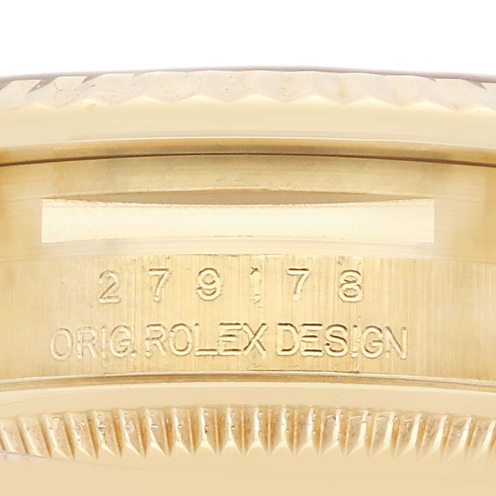 The image shows a close-up of the side of the Rolex President 279178 Women
s Yellow Gold Champagne Dial model, highlighting the engraved design section.