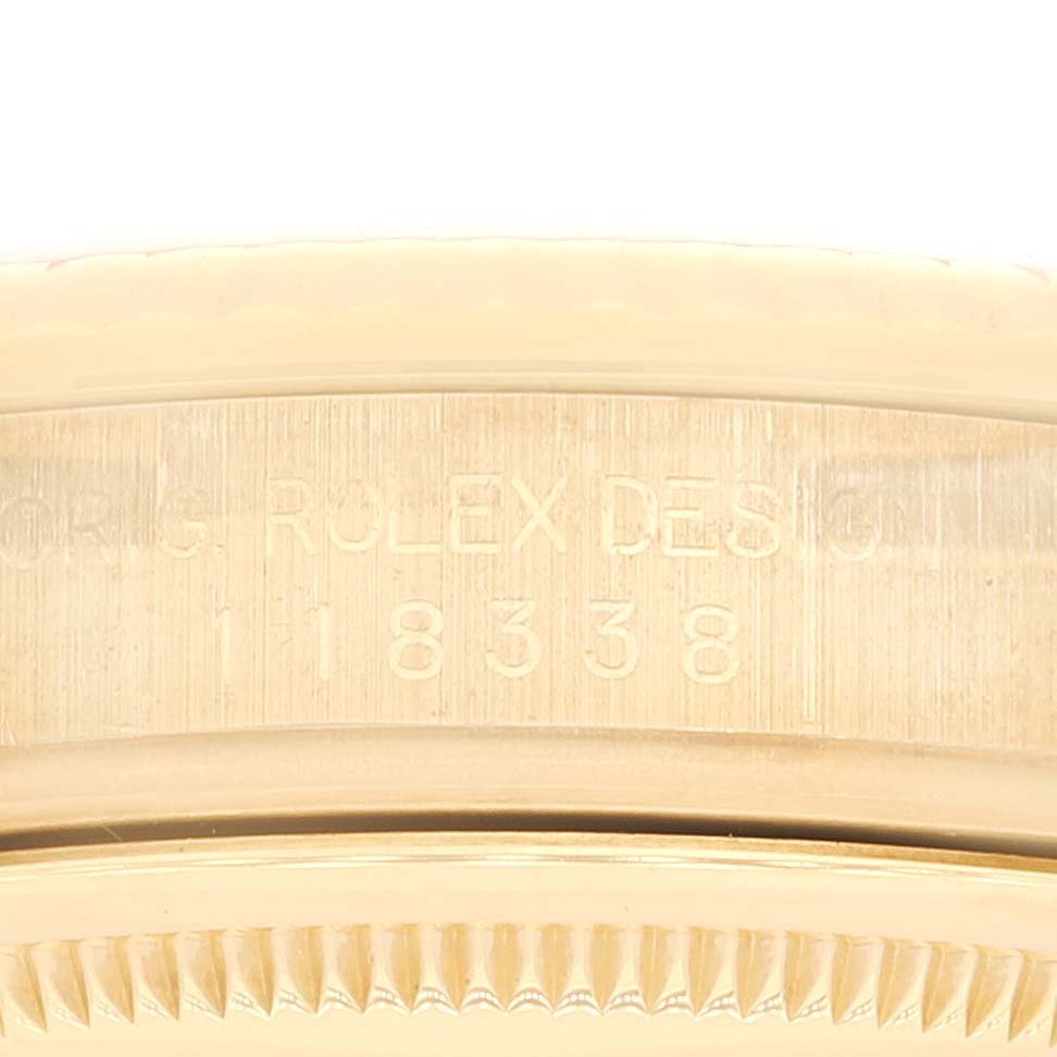 Close-up of a Rolex President 118338 Men
s Yellow Gold Champagne Dial 118338 Men
s Yellow Gold Champagne Dial model showing the engraved design number on the case beneath the bezel.