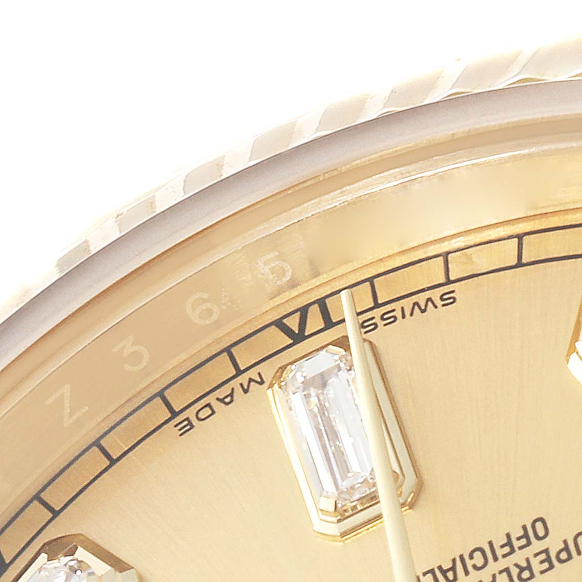This close-up image of the Rolex President 118338 Men
s Yellow Gold Champagne Dial 118338 Men
s Yellow Gold Champagne Dial watch shows the bezel, part of the dial, and a diamond hour marker.