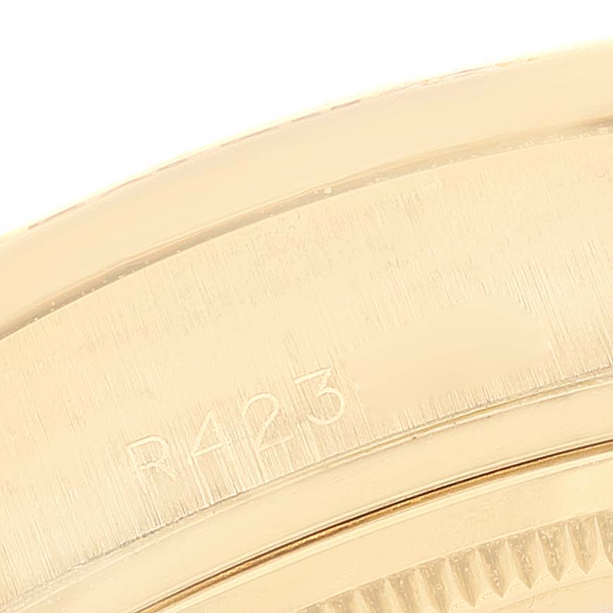 The image shows a close-up of the gold bezel and engravings on the Rolex President 18138 Men
s Yellow Gold Champagne Dial 18138 Men
s Yellow Gold Champagne Dial model watch.