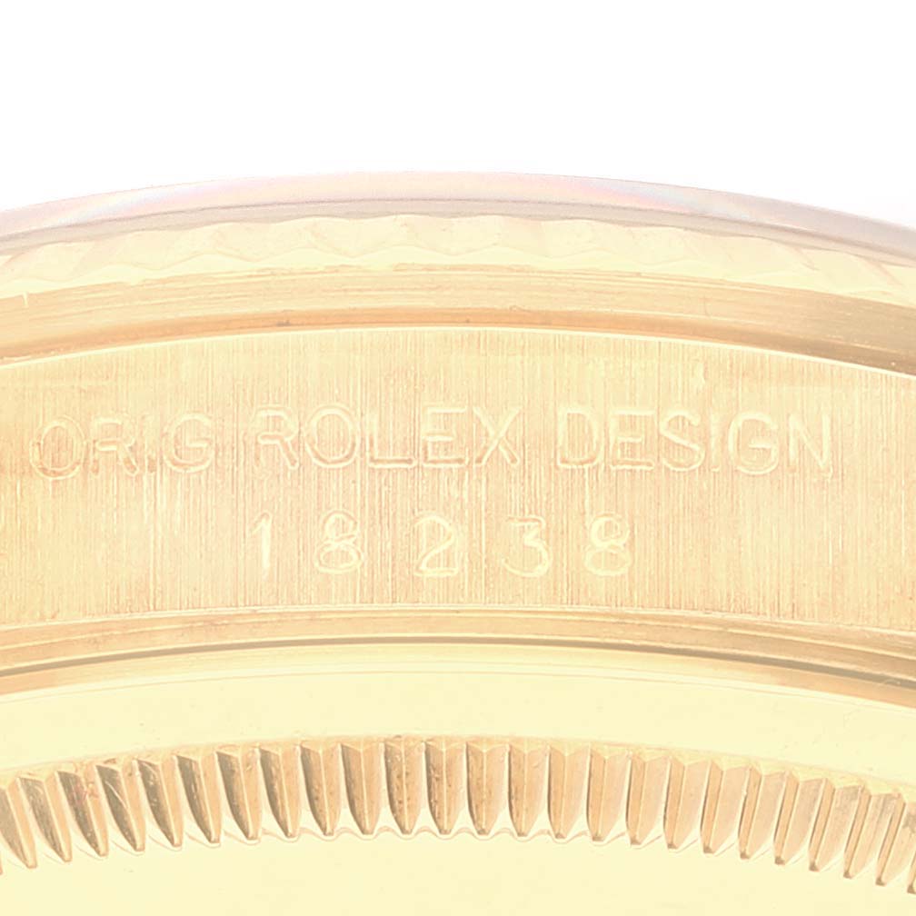 This close-up image shows the engraved side detail of the bezel of a Rolex President 18238 Men's Yellow Gold Champagne Dial 18238 Men's Yellow Gold Champagne Dial model.