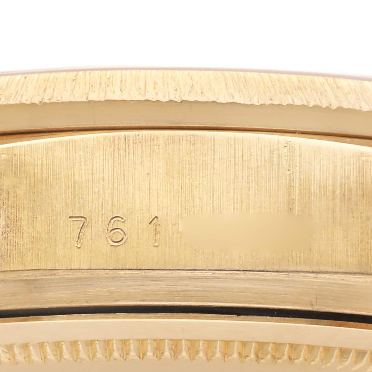 The image shows a close-up of the case side of a Rolex President 18078A Men's Yellow Gold Champagne Dial 18078A Men's Yellow Gold Champagne Dial model, focusing on the serial number engraving.