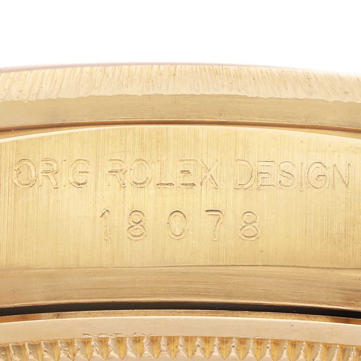 The image shows a close-up of the side of a Rolex President 18078A Men's Yellow Gold Champagne Dial 18078A Men's Yellow Gold Champagne Dial model, highlighting the engraved design numbers.