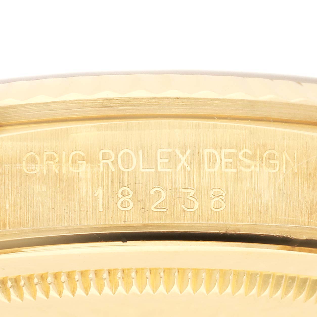 The image shows the side and part of the bezel of a Rolex President 18238 Men's Yellow Gold Champagne Dial 18238 Men's Yellow Gold Champagne Dial watch, with "ORIG ROLEX DESIGN" and the number 18238 engraved.