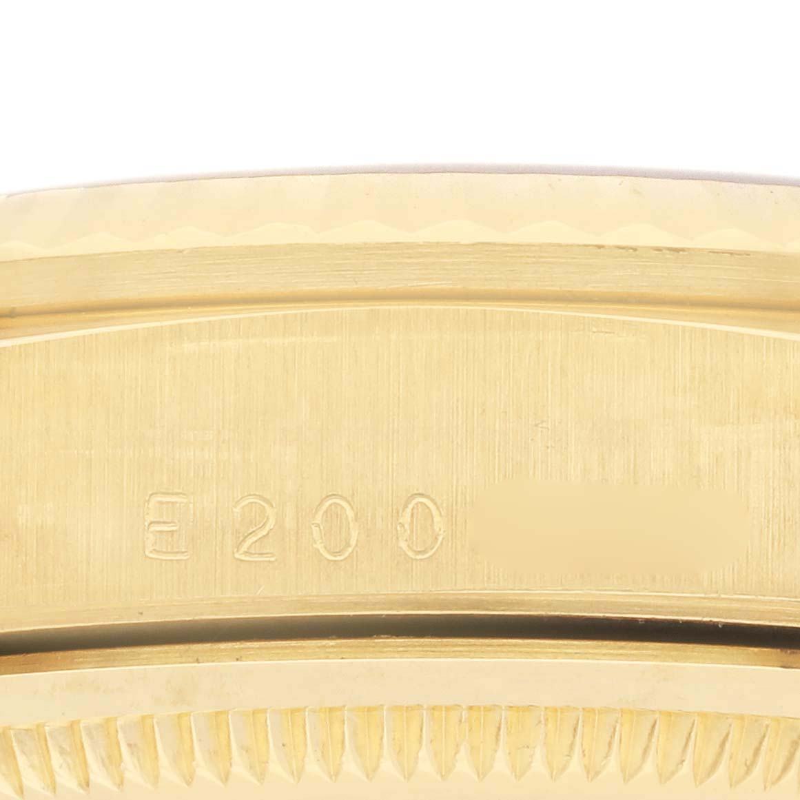 The image shows a close-up of the side of a Rolex President 18238 Men's Yellow Gold Champagne Dial 18238 Men's Yellow Gold Champagne Dial model, focusing on the serial number and case edge.