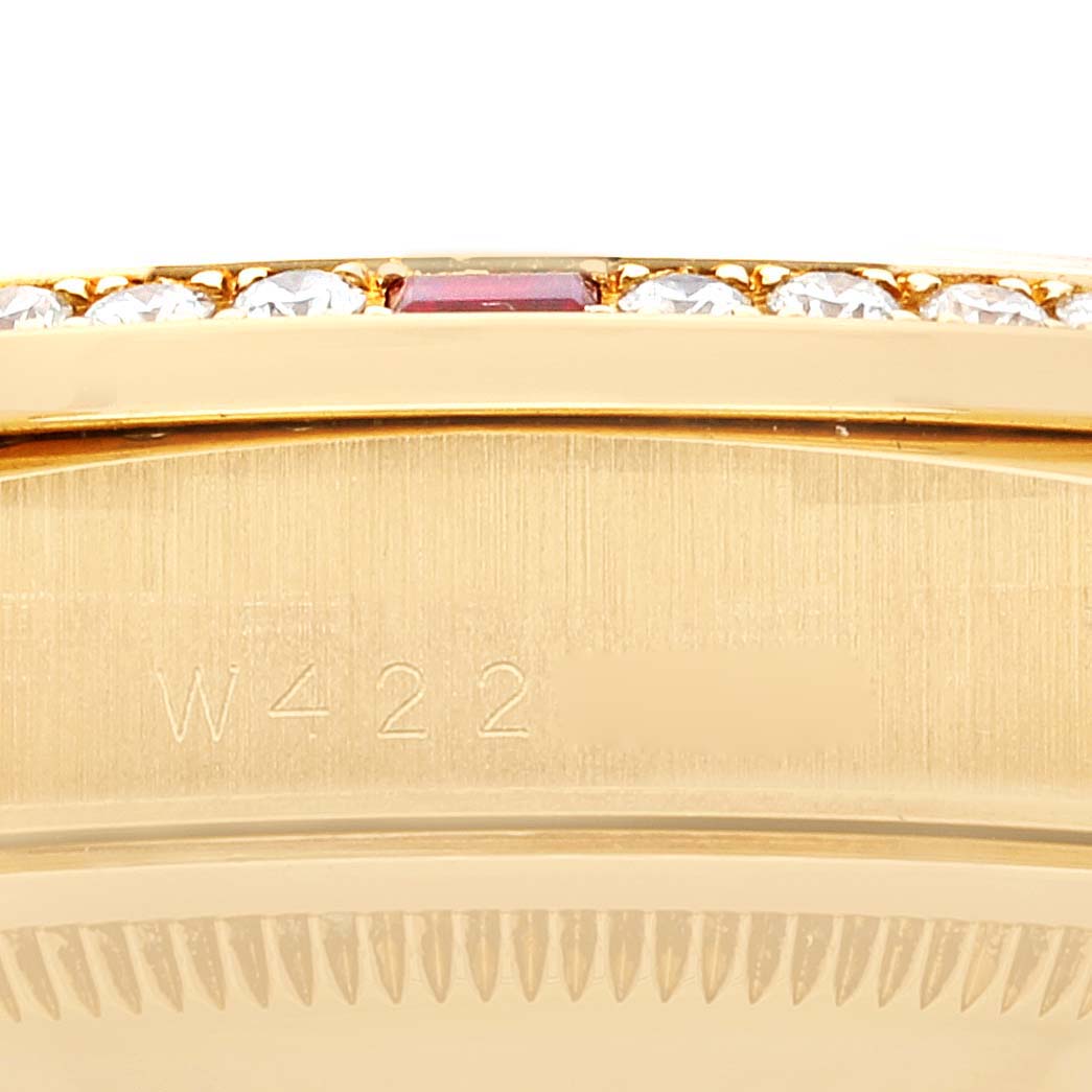 This image shows a close-up angle of the Rolex President 18378 Men
s Yellow Gold Champagne Dial 18378 Men
s Yellow Gold Champagne Dial watch, focusing on part of the bezel and the engraved serial number.