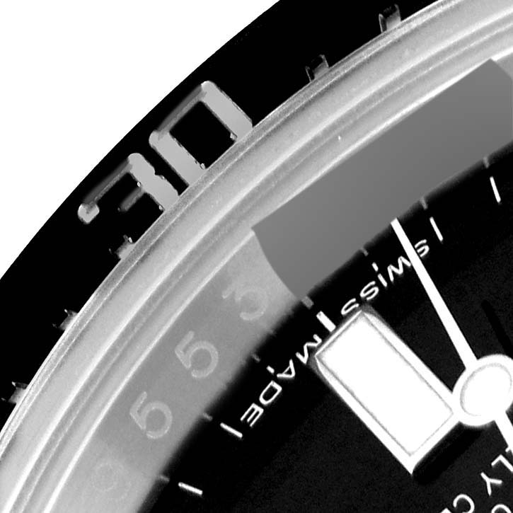 This close-up image of the Rolex Sea-Dweller 116600 Men
s Stainless Steel Black Dial 116600 Men
s Stainless Steel Black Dial watch shows the edge of the dial, minute marks, and a portion of the bezel.
