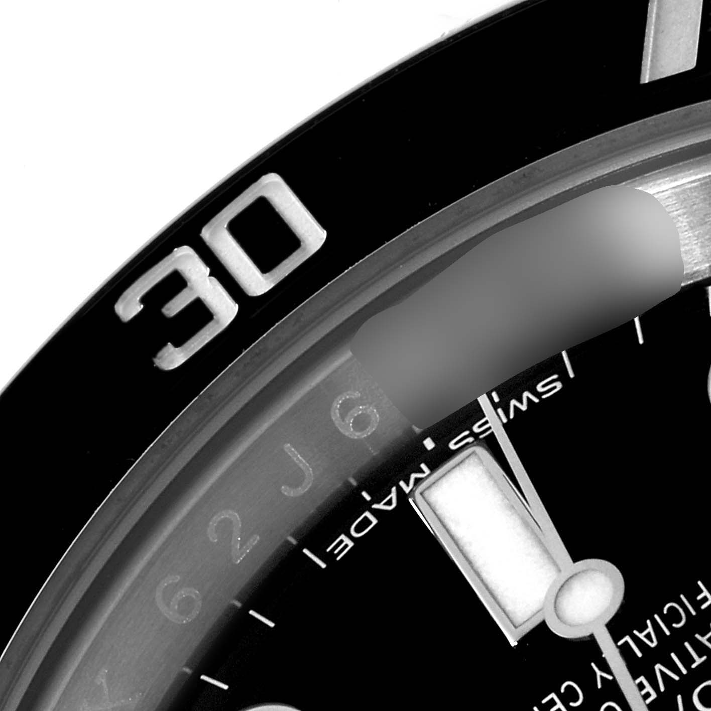 This image shows a close-up of the bezel and part of the dial of a Rolex Submariner 114060 Men
s Stainless Steel Black Dial 114060 Men
s Stainless Steel Black Dial watch, featuring the 30-minute marker.