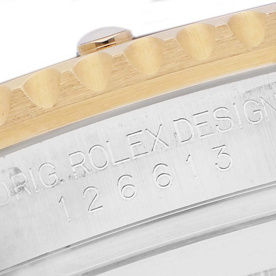 The image shows a side view of the Rolex Submariner 126613 Men
s Steel and Gold (two tone) Black Dial, highlighting the engraved bezel and case details.