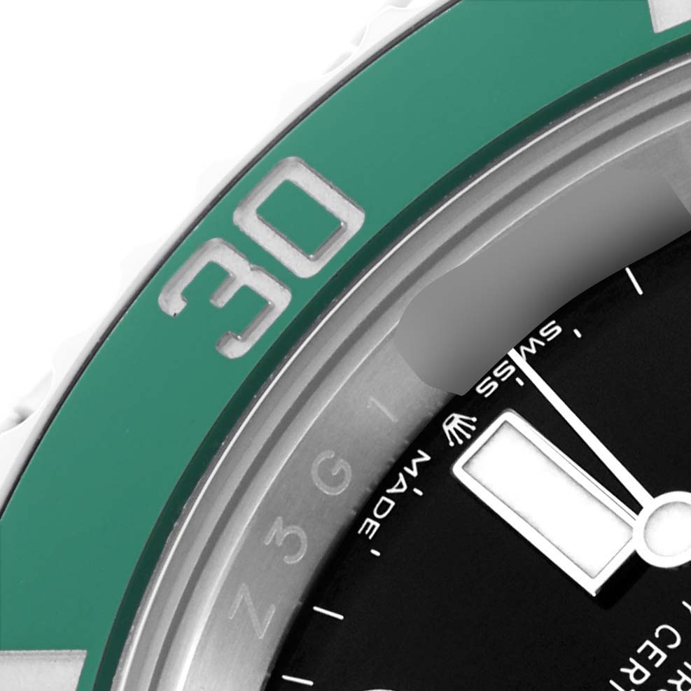 The image shows a close-up of the Rolex Submariner 126610LV Men
s Stainless Steel Black Dial
s bezel and part of the dial from an angled top view.