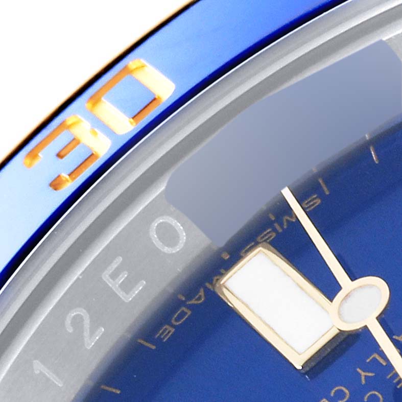 Close-up of the bezel and part of the dial of a Rolex Submariner 116613 Men's Steel and Gold (two tone) Blue Dial 116613 Men's Steel and Gold (two tone) Blue Dial watch, showing the "30" marking and minute hand.