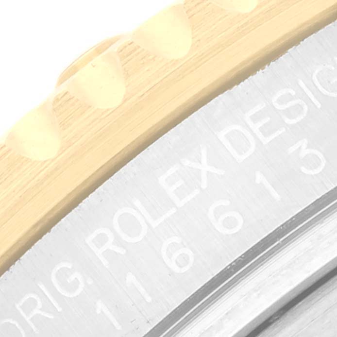 This close-up image shows the bezel and the engraved text on the case of a Rolex Submariner 116613 Men's Steel and Gold (two tone) Blue Dial 116613 Men's Steel and Gold (two tone) Blue Dial watch.