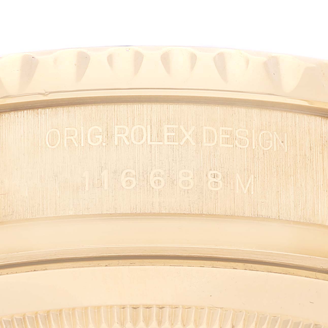 The image shows a close-up of the engraving on the case side of a Rolex Yacht-Master 116688 Men's Yellow Gold White Dial 116688 Men's Yellow Gold White Dial watch.