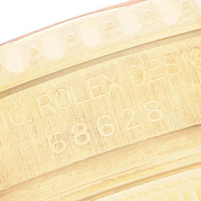 This image shows a close-up of the engraved serial number and branding on the bezel of a Rolex Yacht-Master 68628 Men's Yellow Gold Mother of Pearl Dial 68628 Men's Yellow Gold Mother of Pearl Dial watch.