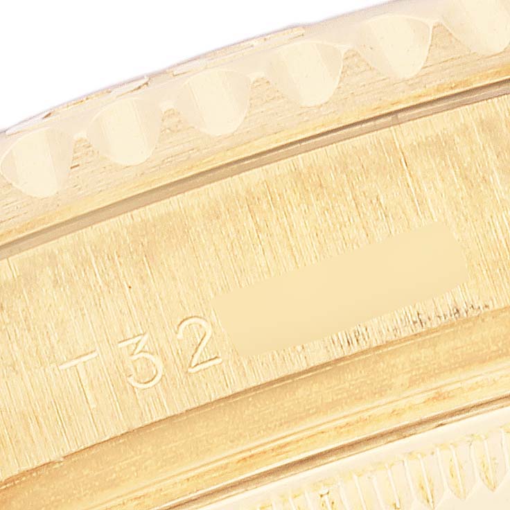 This image shows a close-up angle of the engraved bezel and edge of the case of a Rolex Yacht-Master 68628 Men's Yellow Gold Mother of Pearl Dial 68628 Men's Yellow Gold Mother of Pearl Dial watch.