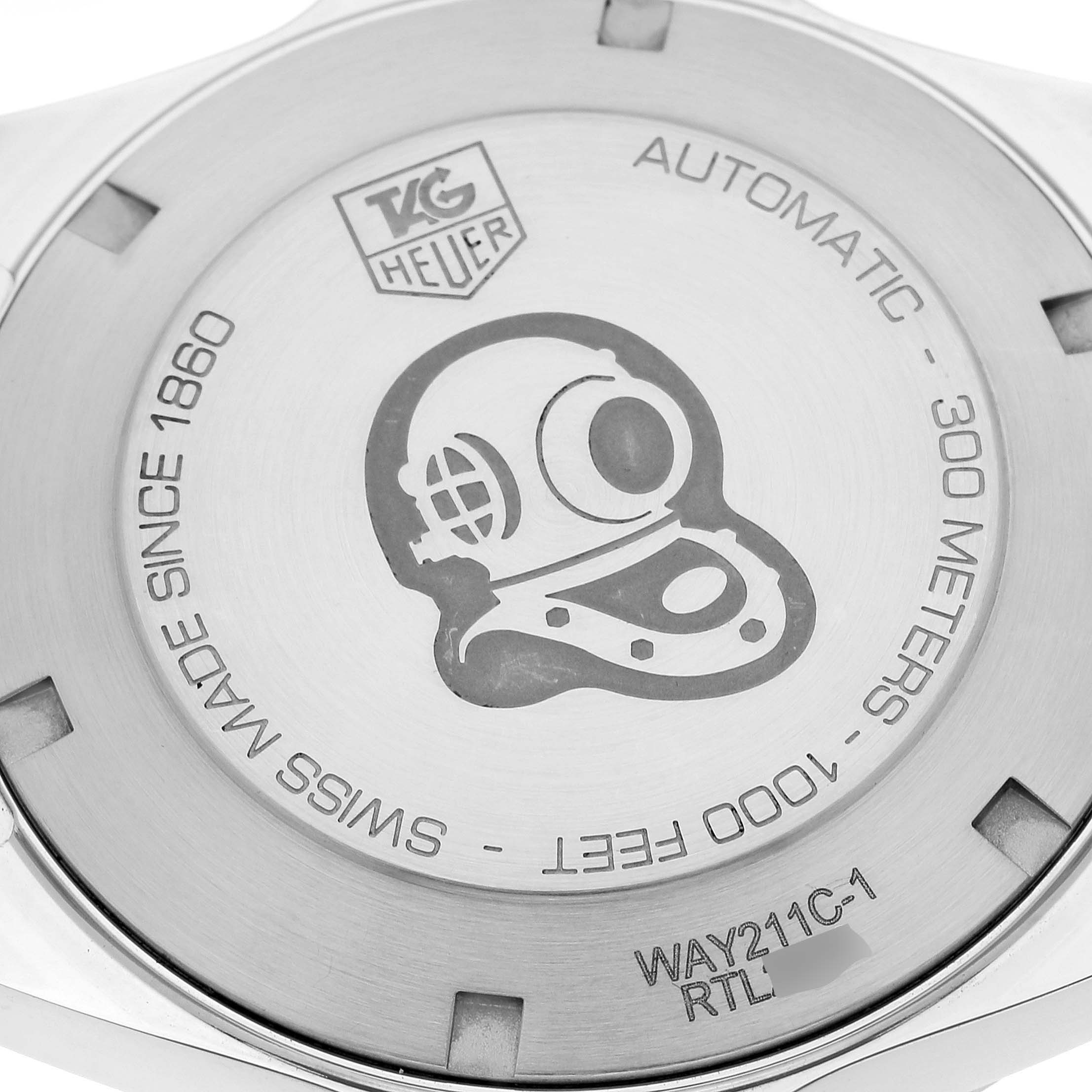 The image shows the case back of a Tag Heuer Aquaracer WAY211C.BA0928 Men's Stainless Steel Blue Dial WAY211C.BA0928 Men's Stainless Steel Blue Dial watch, featuring engravings and a diving helmet design.