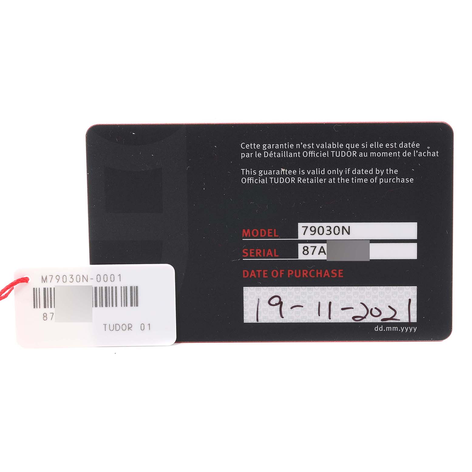 The image shows the warranty card and tag for the Tudor Heritage Black Bay M79030N-0001 Men
s Stainless Steel Black Dial M79030N-0001 Men
s Stainless Steel Black Dial watch model 79030N, displaying model, serial number, and purchase date.