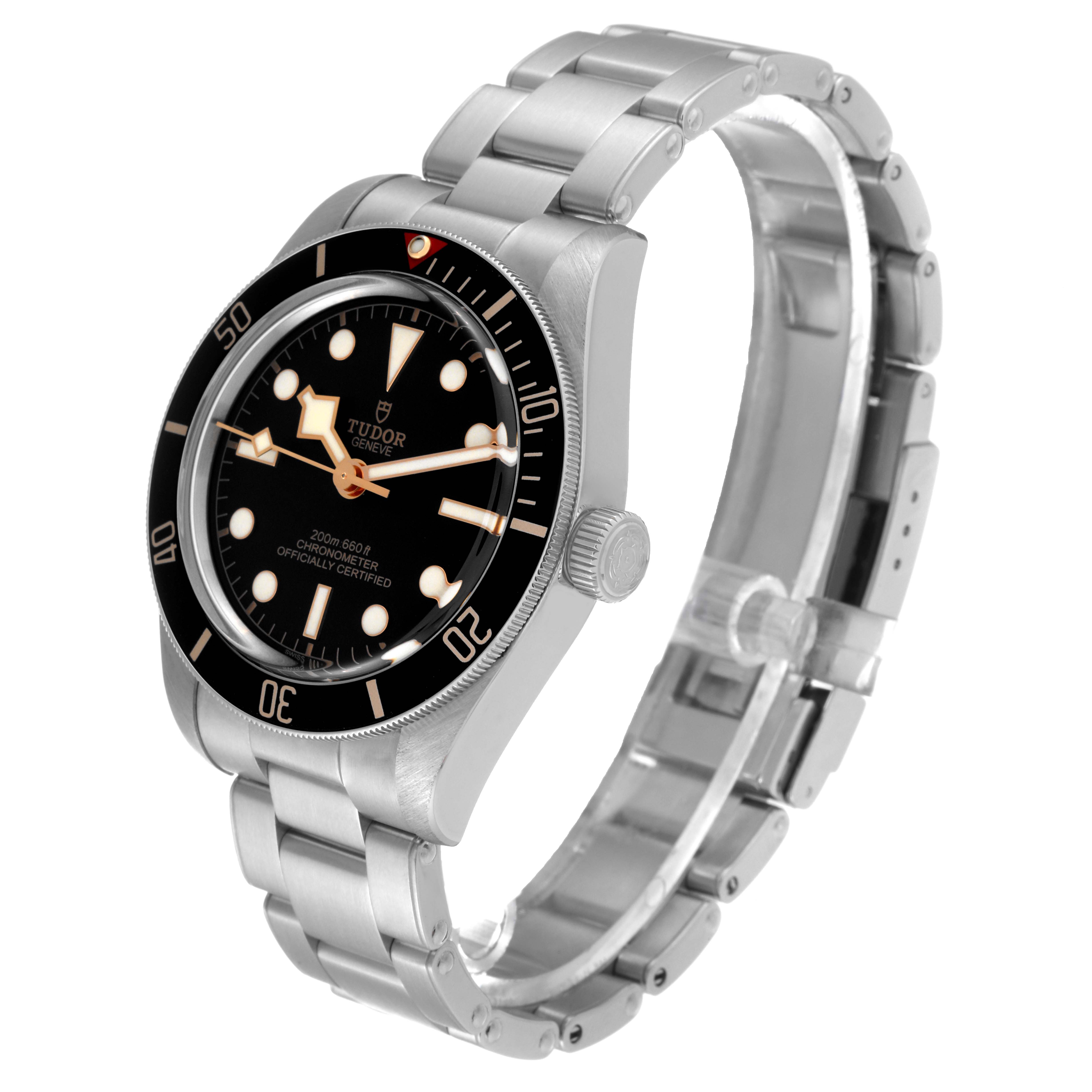 The image shows a Heritage Black Bay model watch by Tudor at a three-quarter angle showcasing the dial, bezel, crown, and bracelet.
