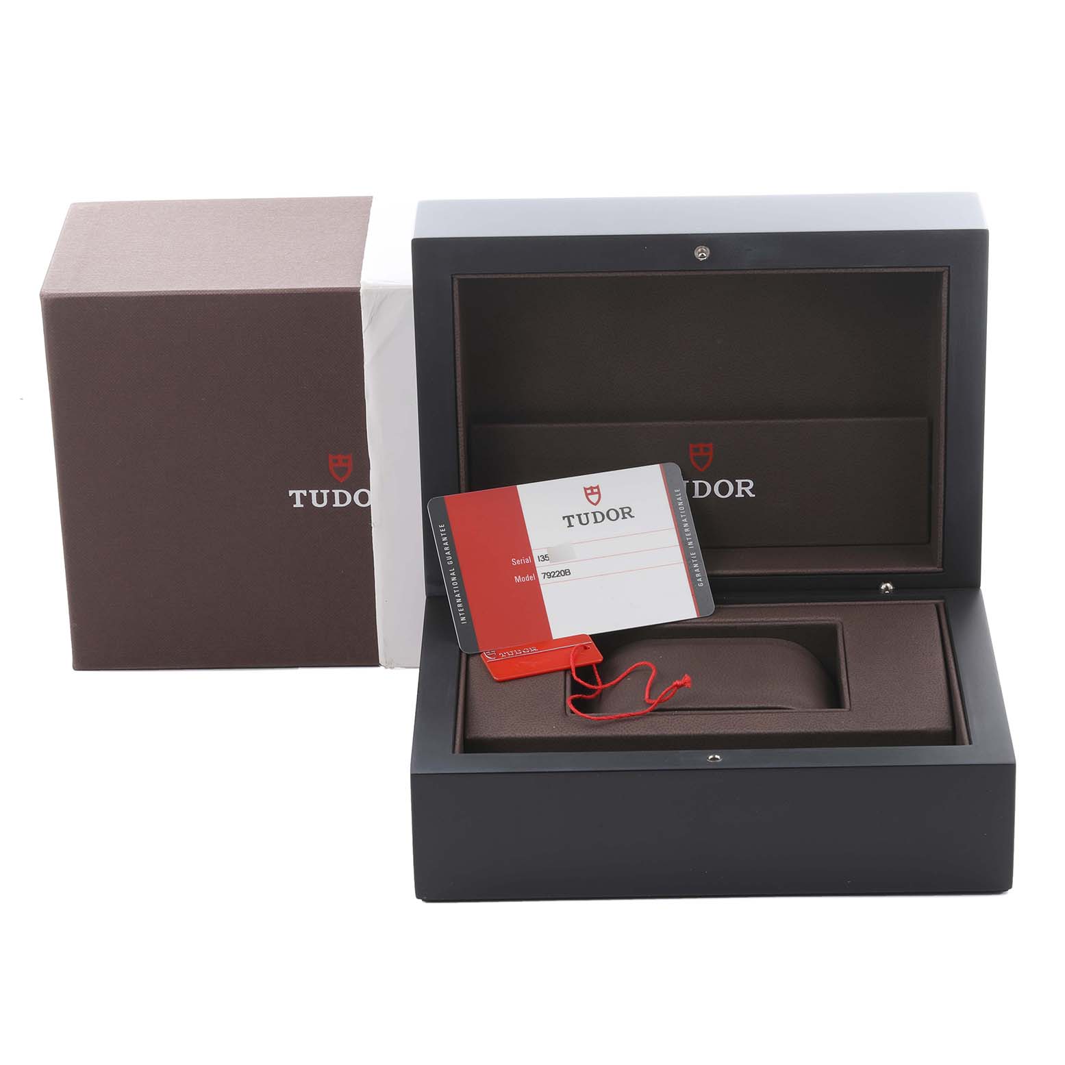 The image shows Tudor Heritage Black Bay 79220B Men
s Stainless Steel Black Dial 79220B Men
s Stainless Steel Black Dial packaging, including the box and warranty card.