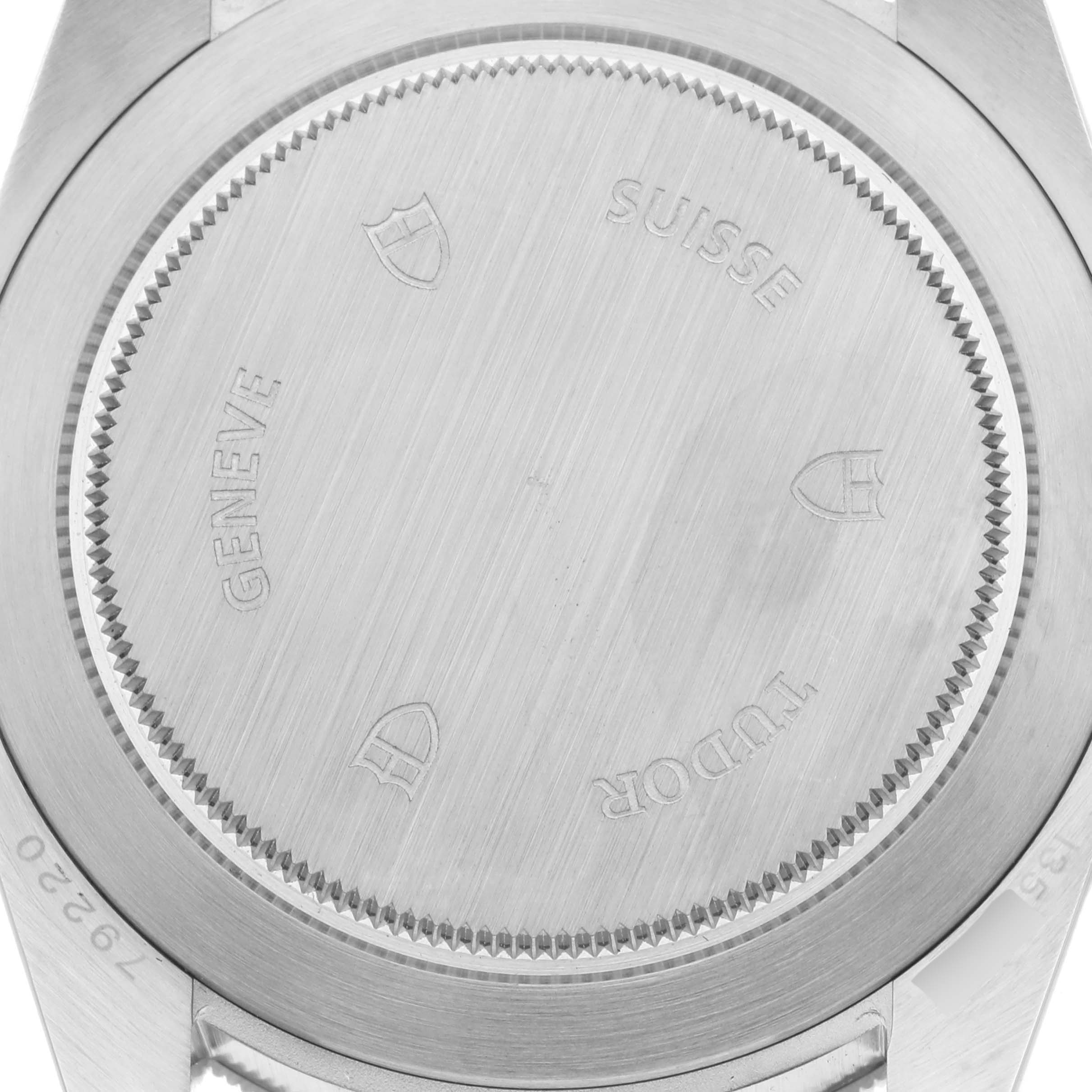 The image shows the back view of the Tudor Heritage Black Bay 79220B Men
s Stainless Steel Black Dial 79220B Men
s Stainless Steel Black Dial watch, highlighting the case back with engraved details.