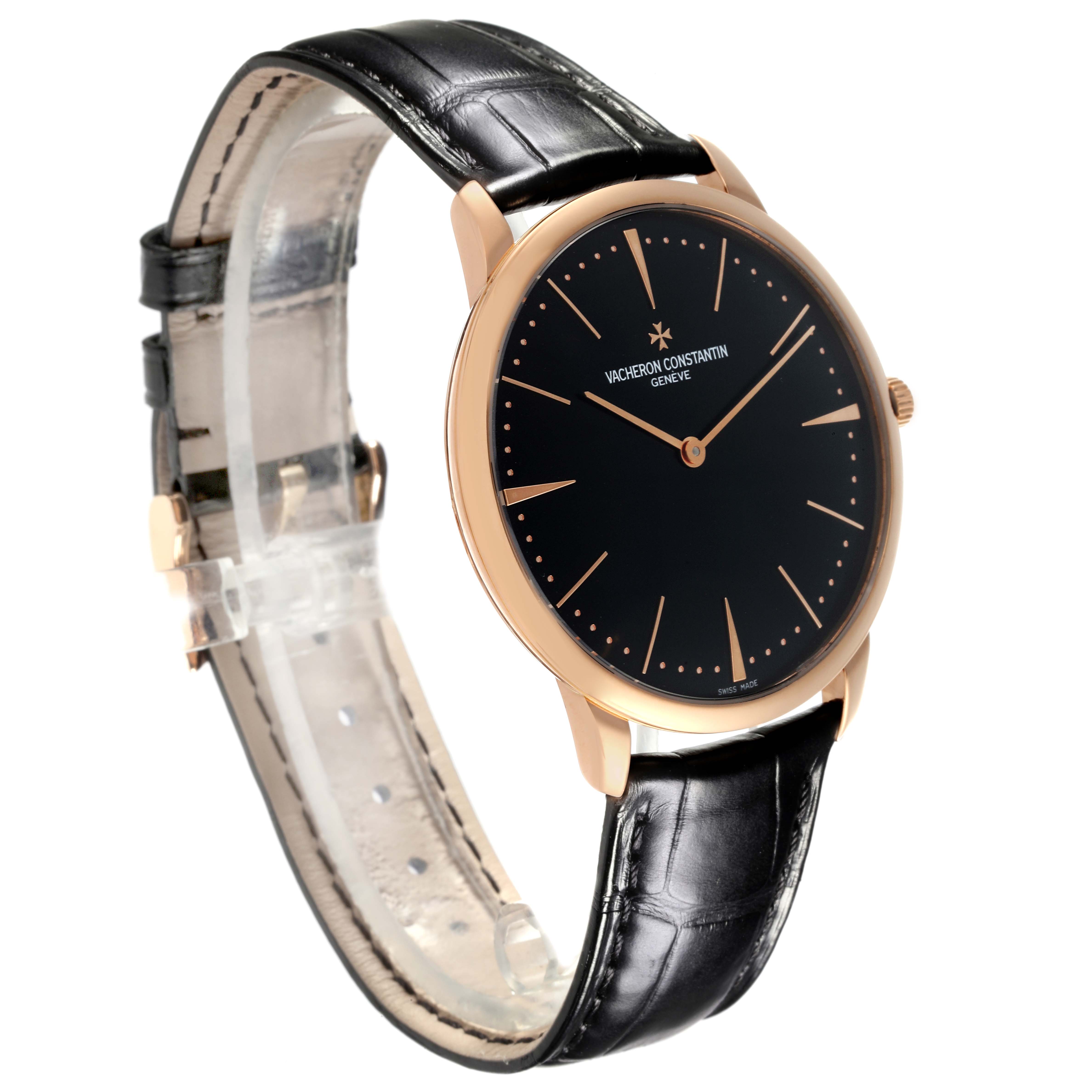 The Patrimony model by Vacheron Constantin is shown at a three-quarter angle, highlighting the dial, hands, and black leather strap.