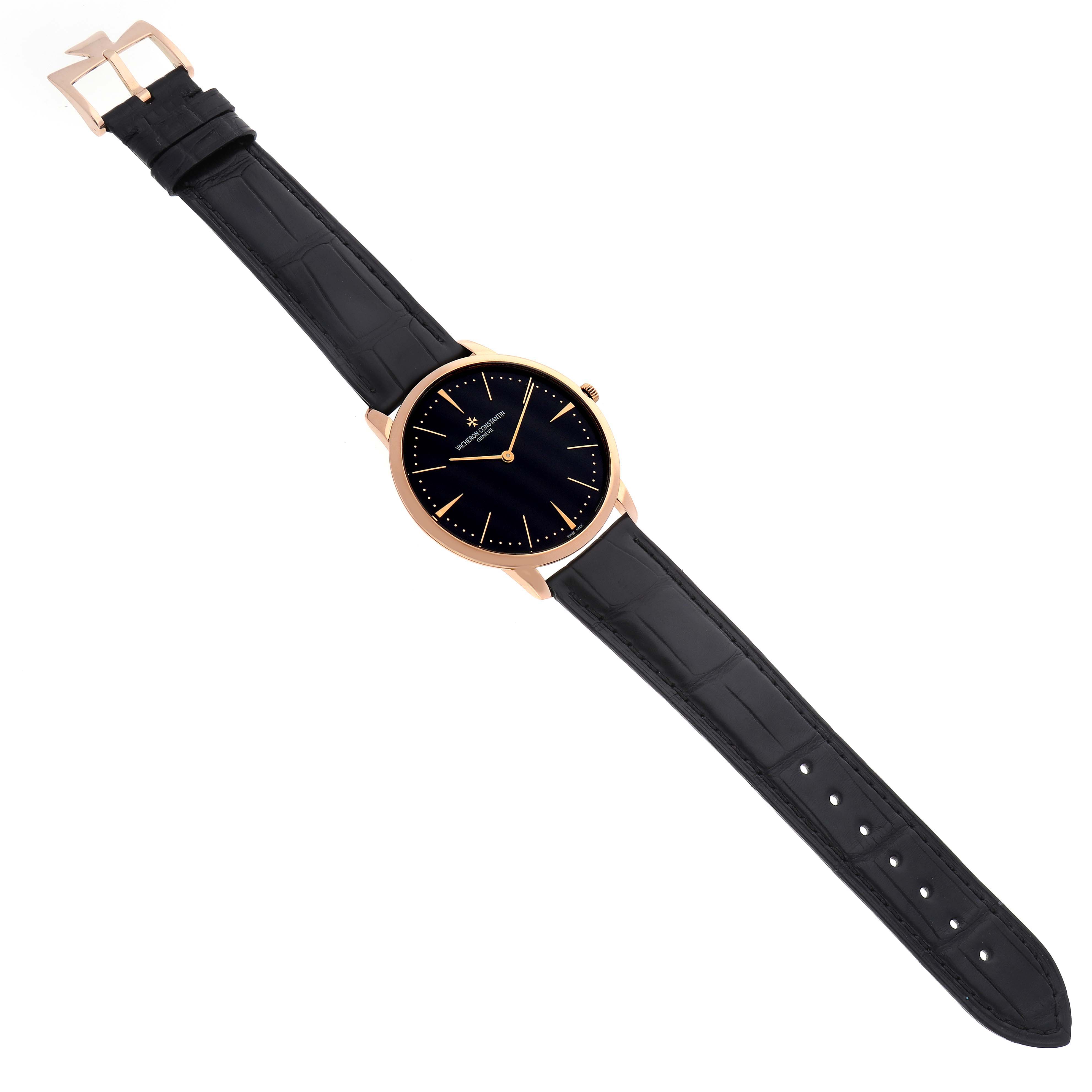 The Vacheron Constantin Patrimony 81180 Men's Rose Gold Black Dial 81180 Men's Rose Gold Black Dial watch is shown from an overhead angle featuring the full face and black leather strap.