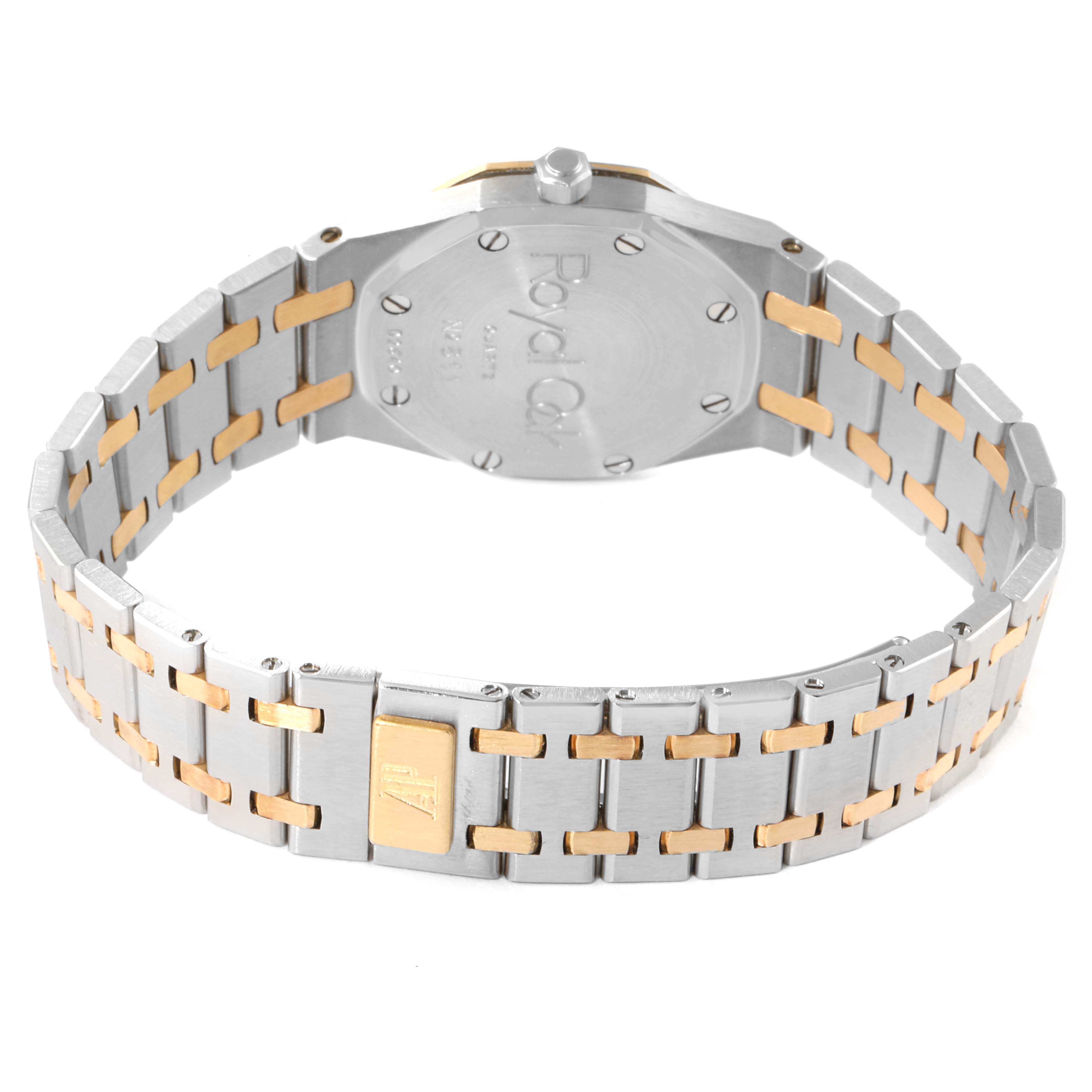 The image shows the back and bracelet of a Royal Oak watch by Audemars Piguet, highlighting its two-tone metal design.