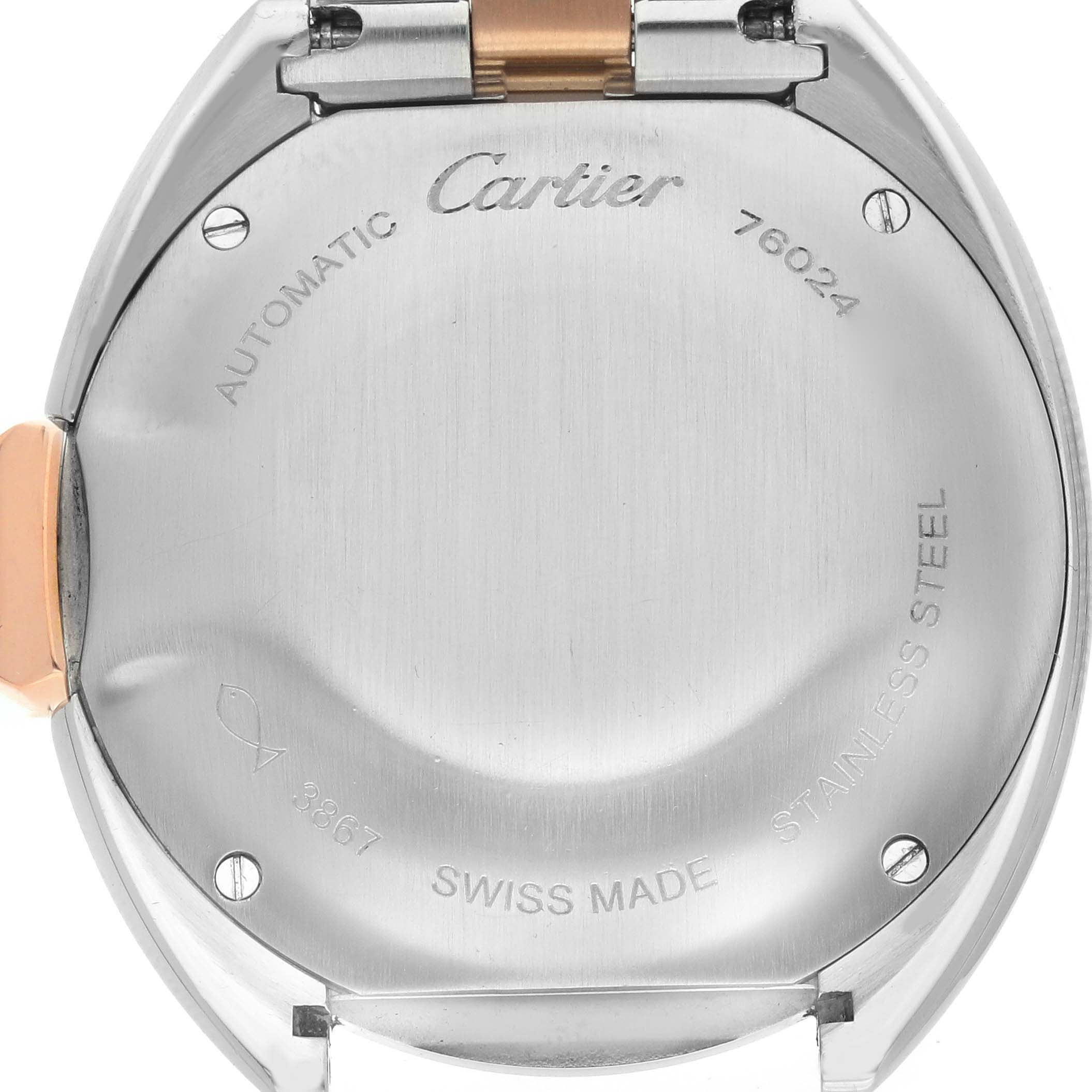 The image shows the back of a Cartier Clé watch displaying engravings and part of the bracelet hinge.