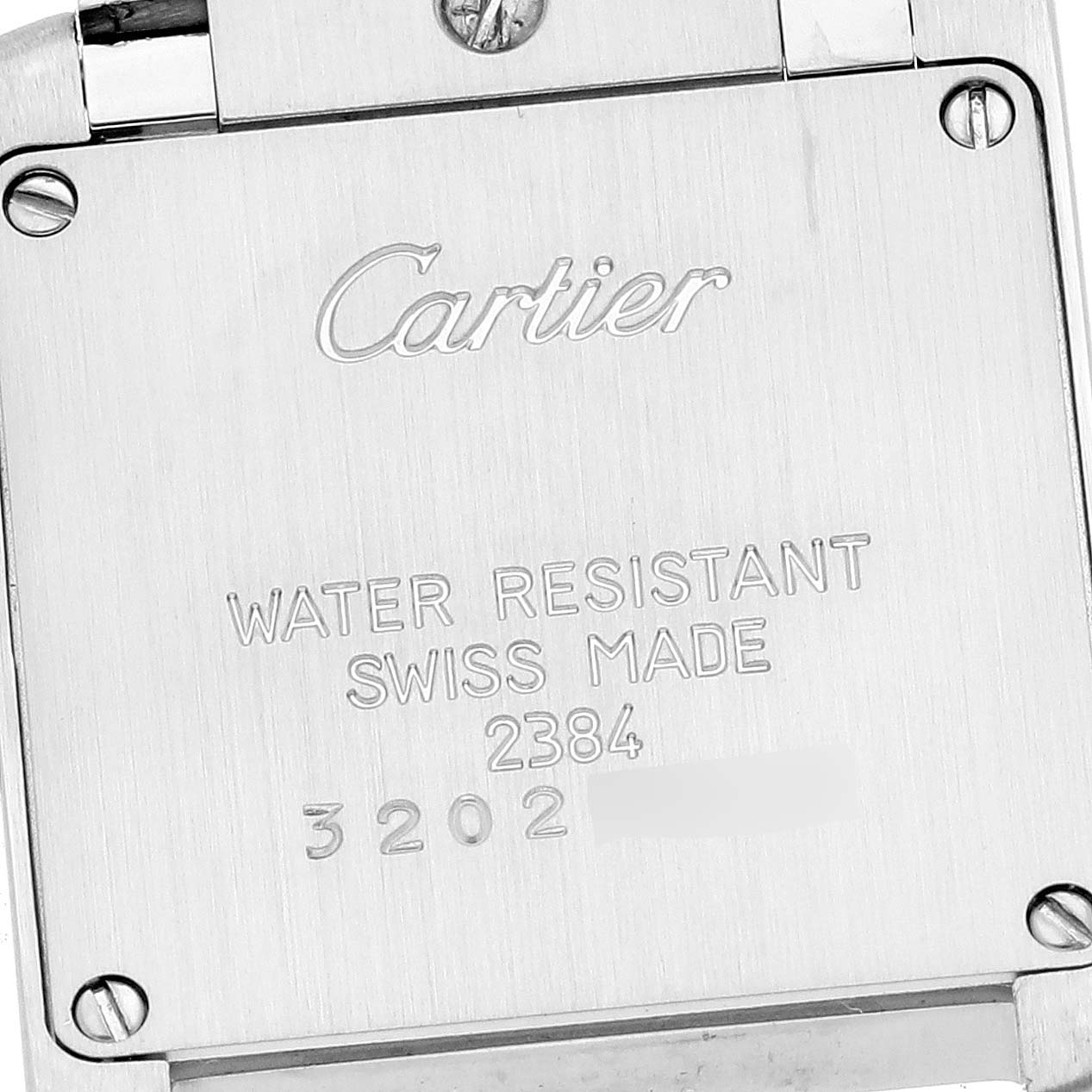 The image shows the back of a Cartier Tank Française watch, highlighting the brand and watch details engravings.