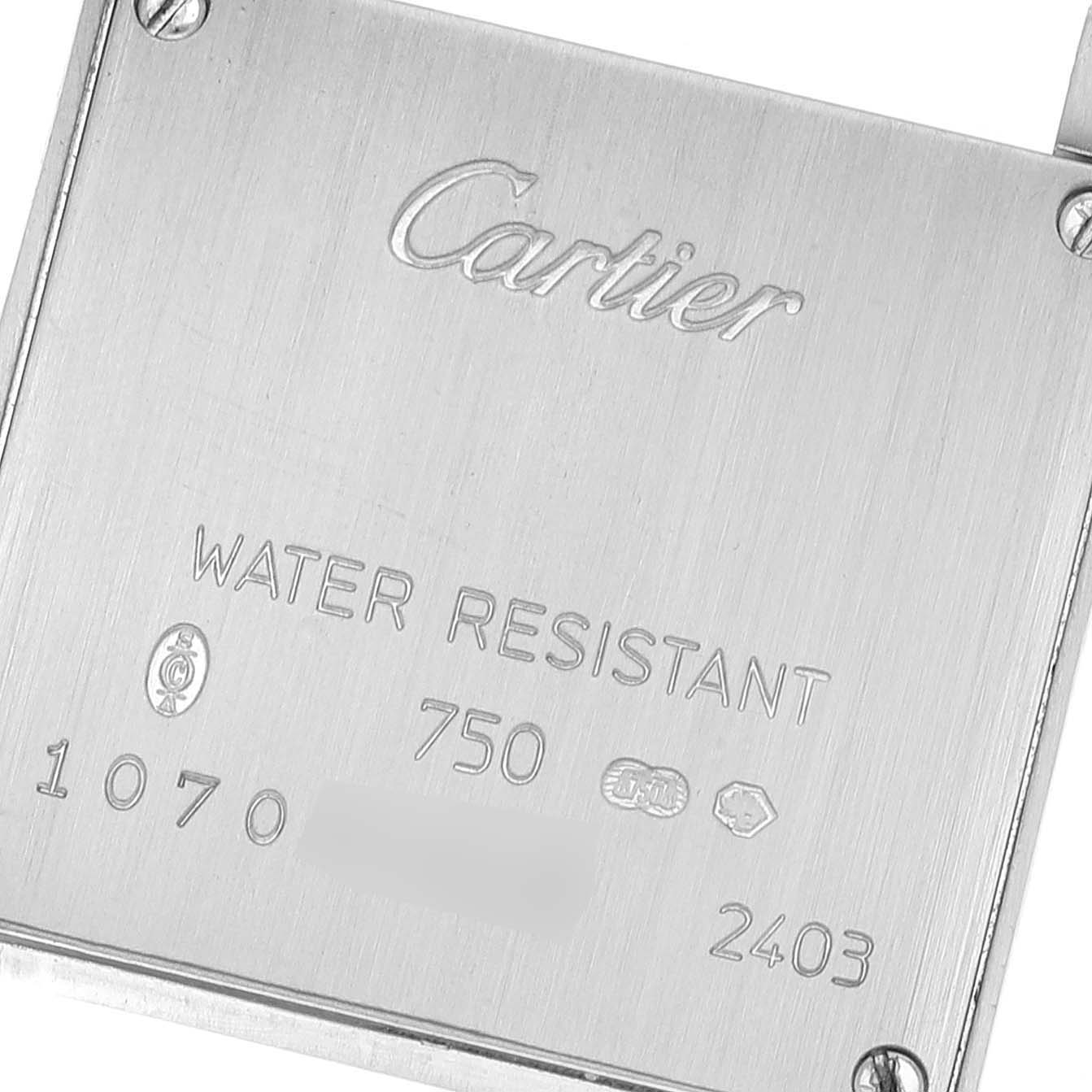 The image shows the back case of a Cartier Tank Française watch, engraved with "Cartier" and other inscriptions.