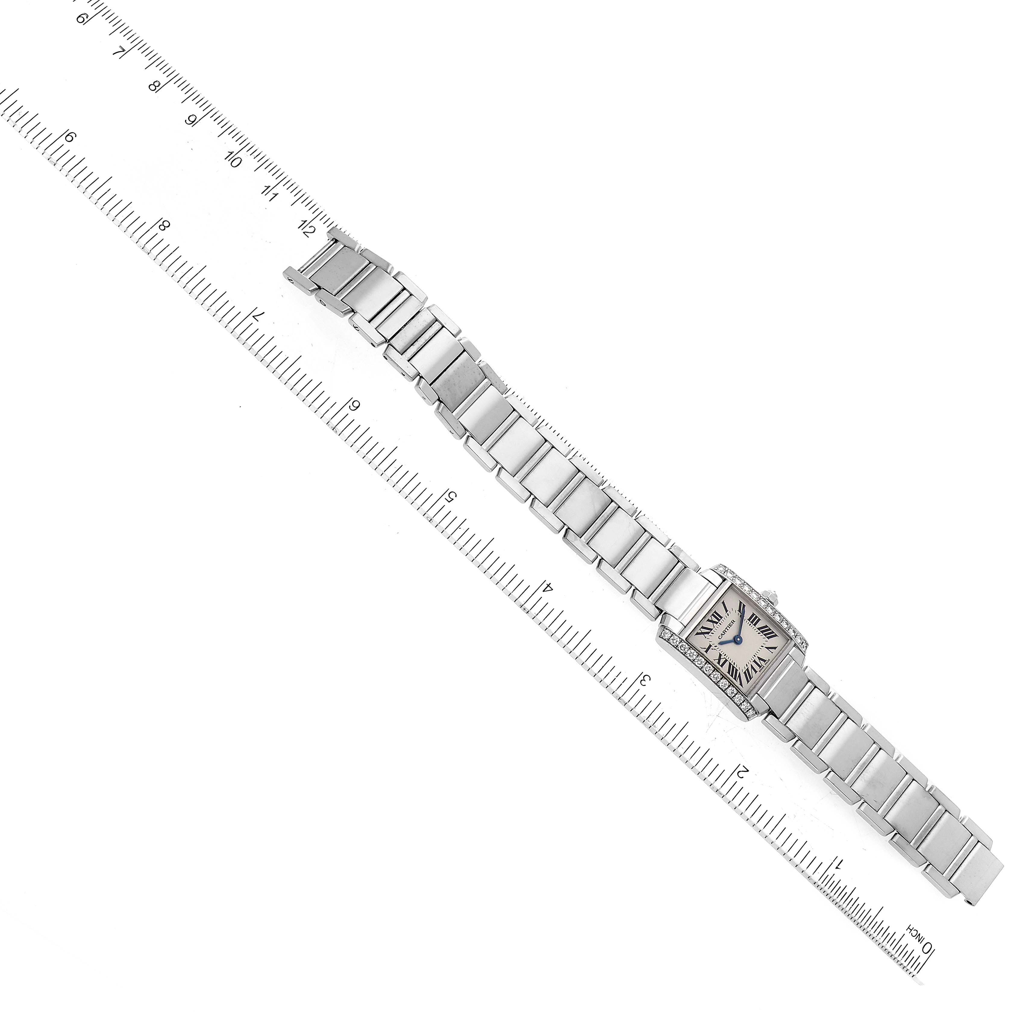 This image shows a Cartier Tank Francaise WE1002S3 Women's White Gold Silver Dial WE1002S3 Women's White Gold Silver Dial watch placed flat next to a ruler for measurement.