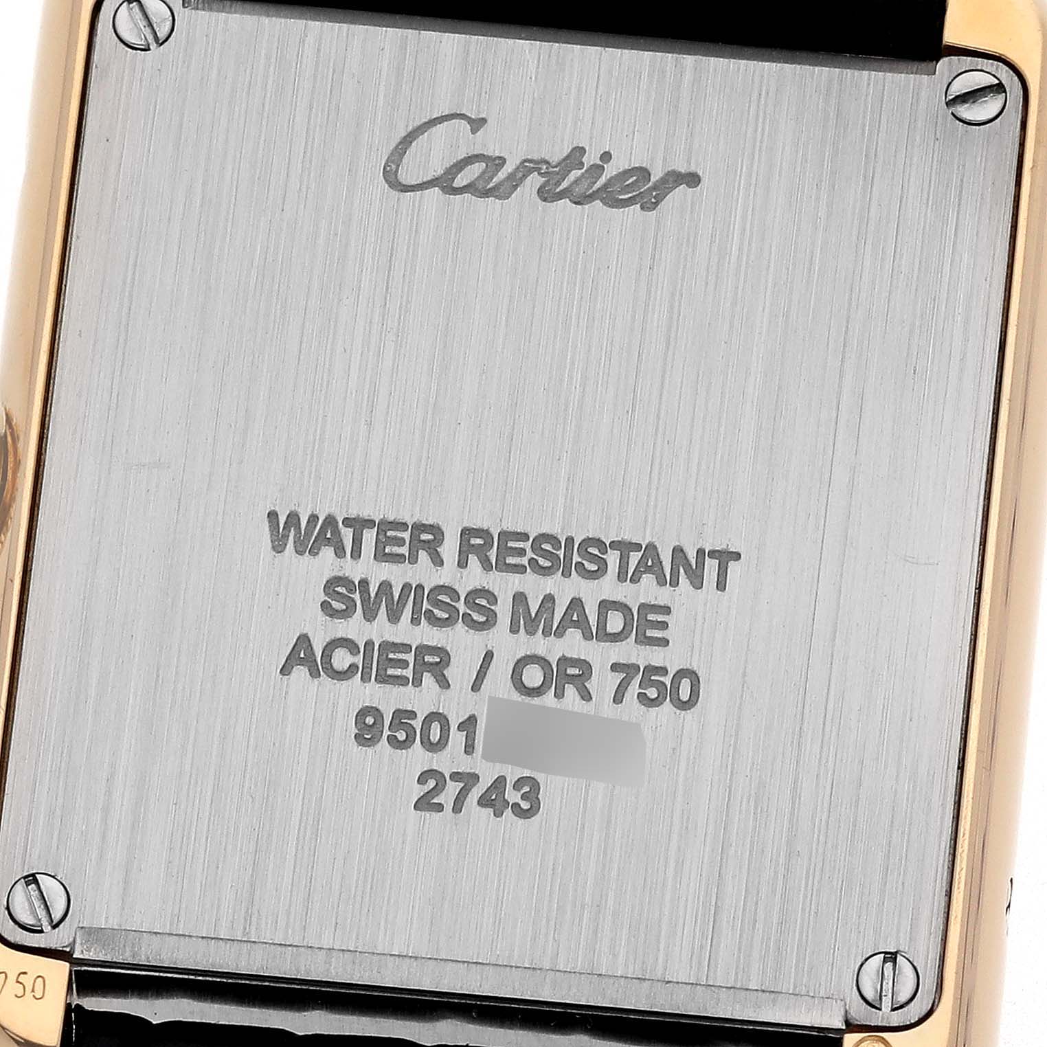 The image shows the back case of the Cartier Tank Solo W1018755 Women's Steel and Gold (two tone) Silver Dial W1018755 Women's Steel and Gold (two tone) Silver Dial watch, highlighting engravings and case screws.