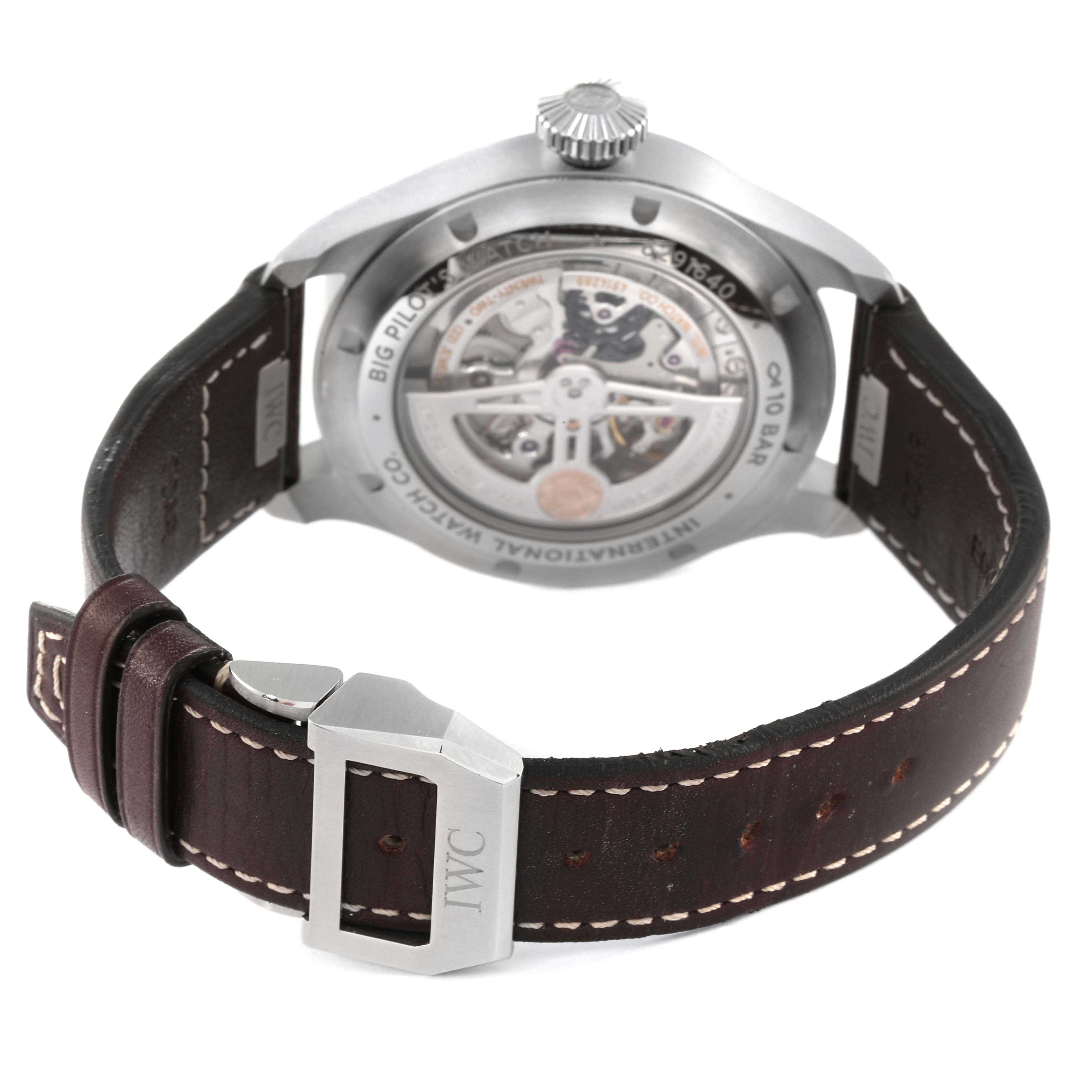 The image shows the back view of an IWC Pilot IW329301 Men
s Stainless Steel Black Dial IW329301 Men
s Stainless Steel Black Dial model, displaying the movement mechanism and the leather strap with an IWC buckle.