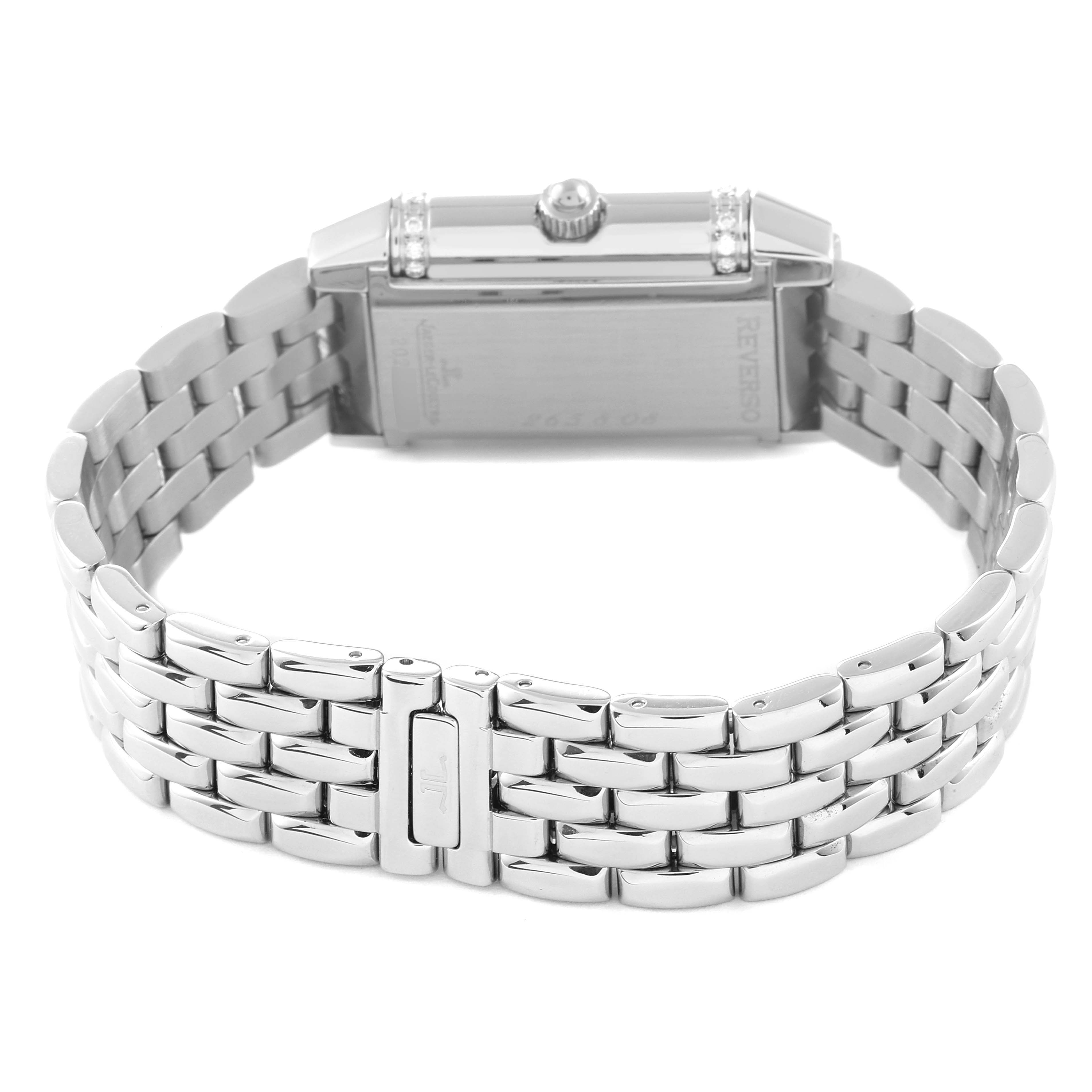 The image shows the back and side view of a Jaeger-LeCoultre Reverso watch, highlighting its metal bracelet and clasp.