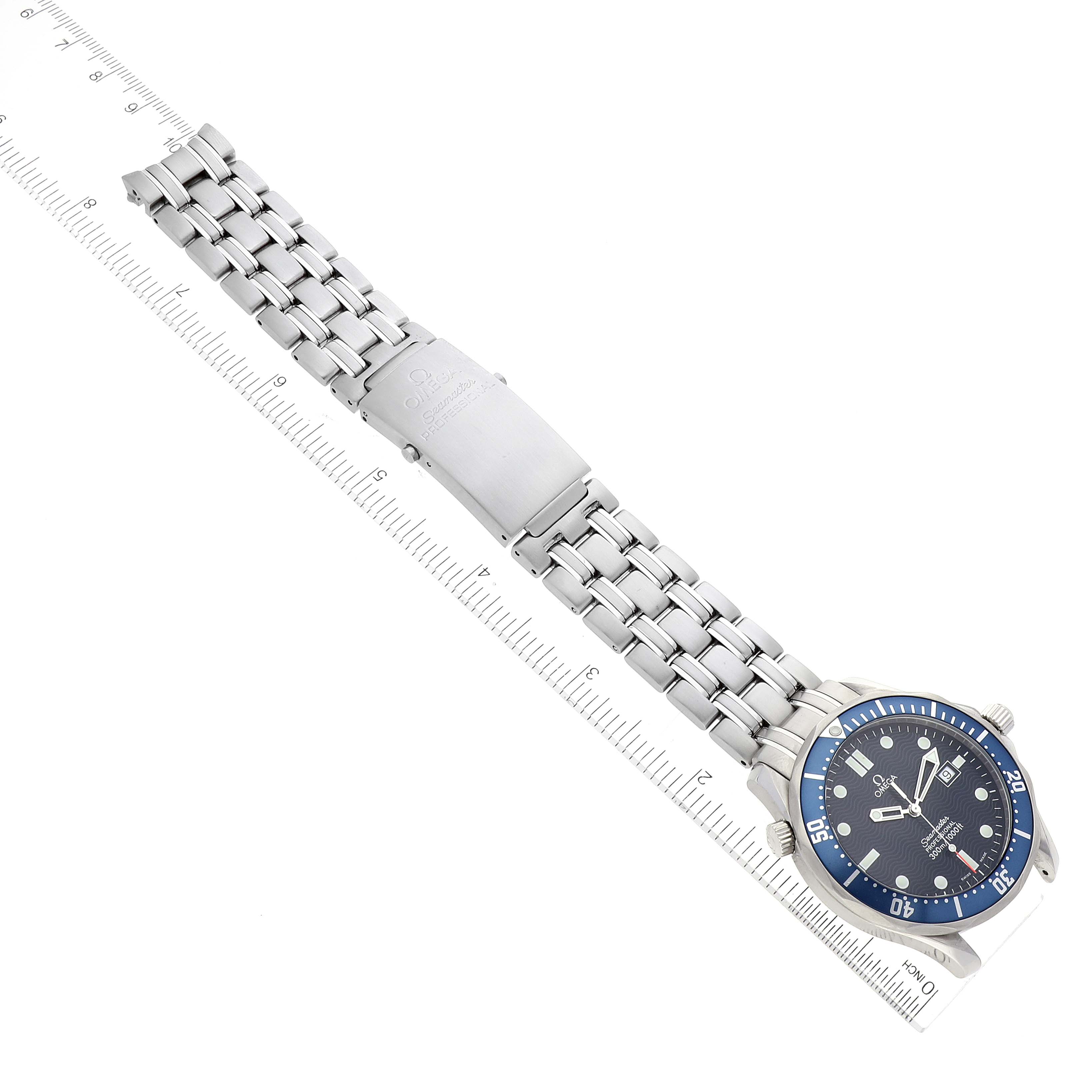 The image shows an overhead view of an Omega Seamaster 2541.80.00 Men's Stainless Steel Blue Dial 2541.80.00 Men's Stainless Steel Blue Dial watch, highlighting its face, bezel, bracelet, and clasp with a ruler for scale.