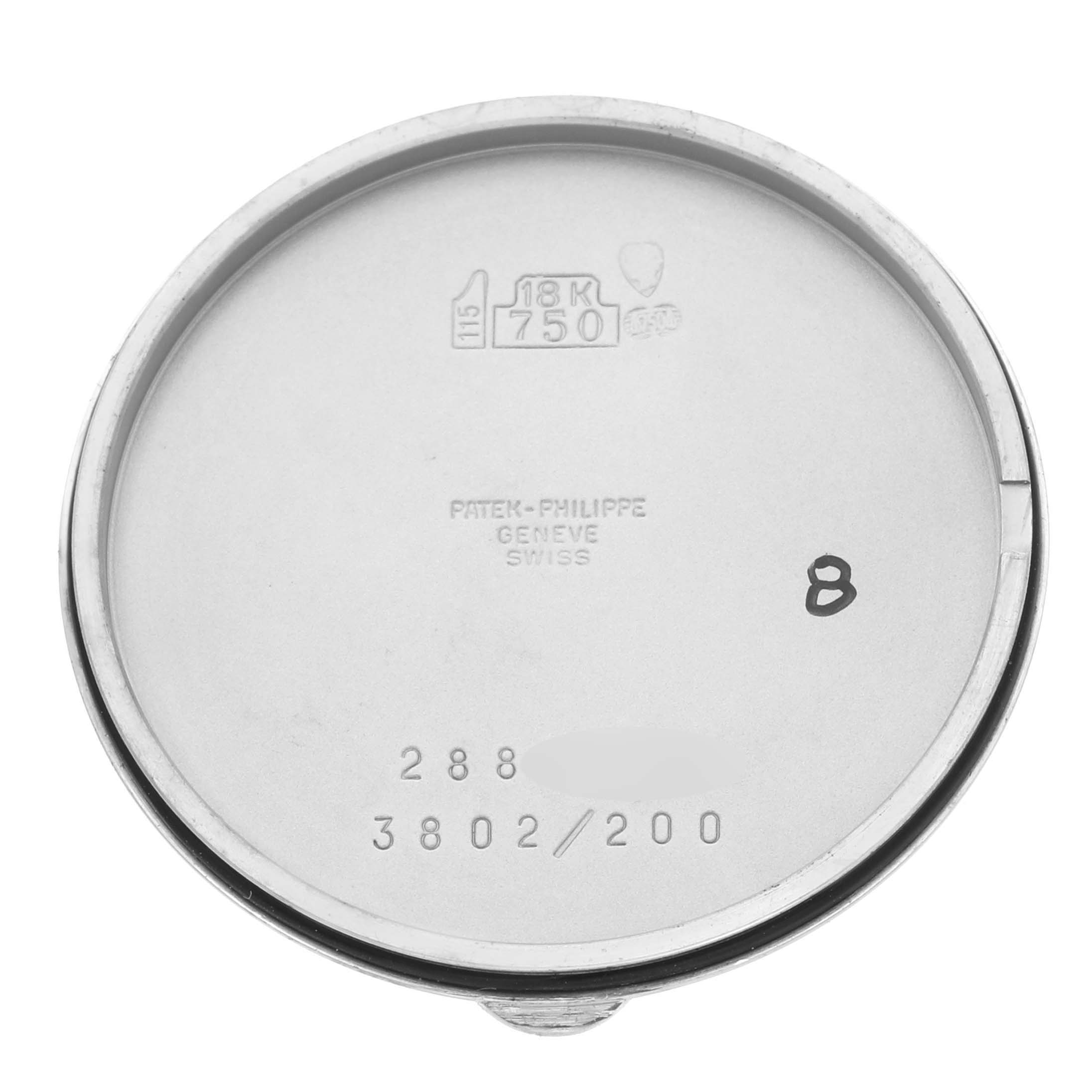 The image shows the inner side of the Patek Philippe Calatrava 3802/200G-001 Men
s White Gold White Dial 3802/200G-001 Men
s White Gold White Dial watch case back with engravings and hallmarks.