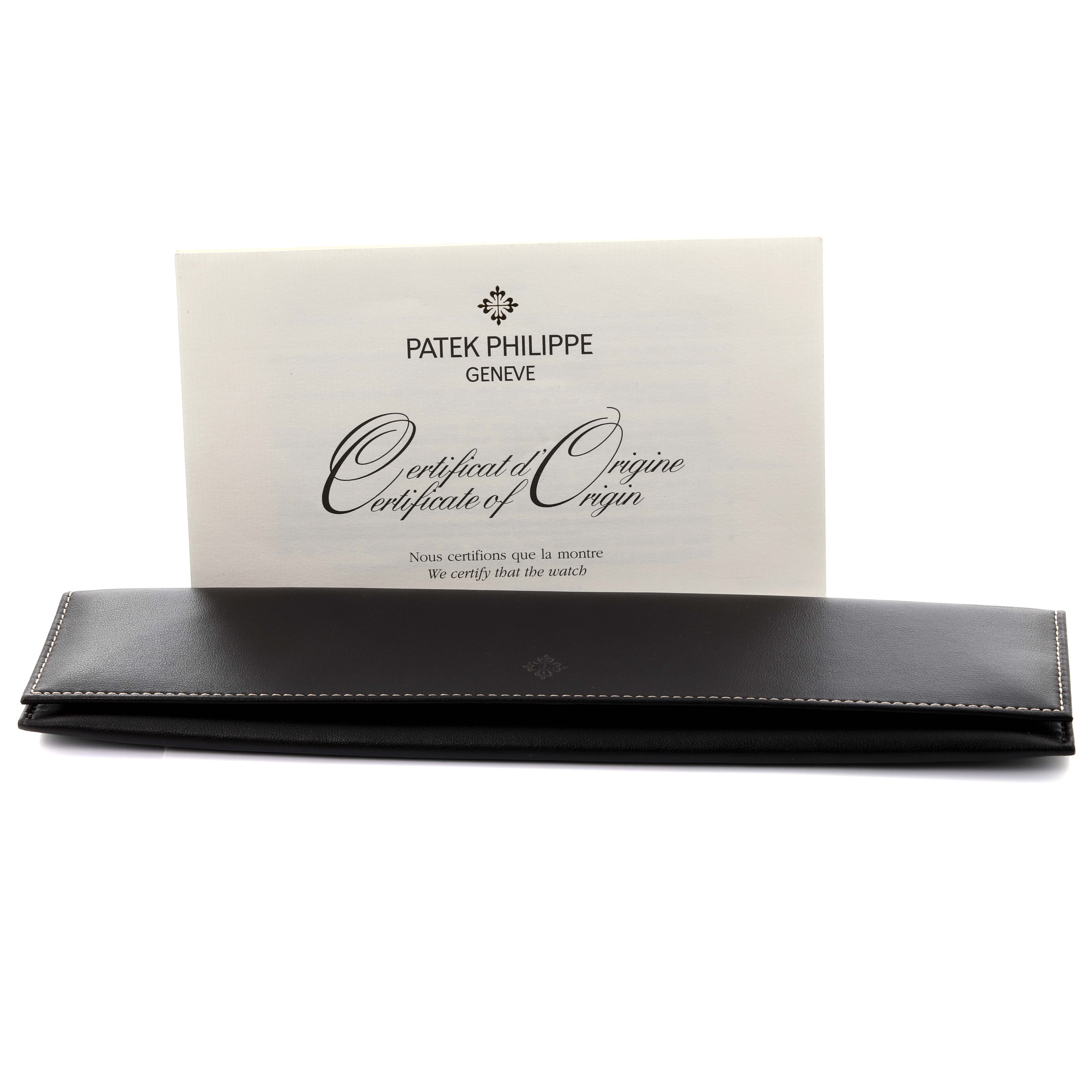 The image shows a Patek Philippe Calatrava 5119G-001 Men
s White Gold White Dial 5119G-001 Men
s White Gold White Dial watch case and a Certificate of Origin, viewed from the front.