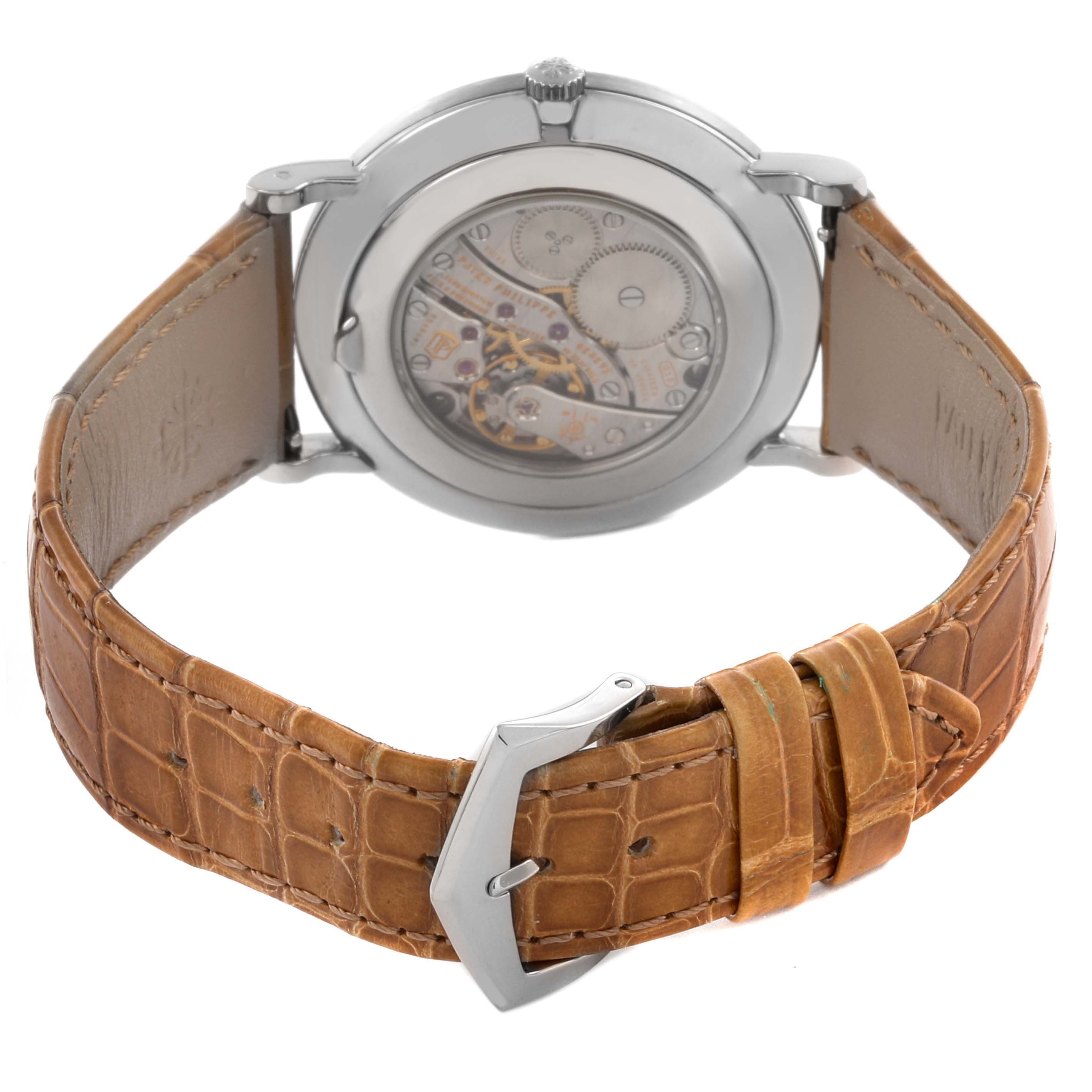 The image shows the back view of the Patek Philippe Calatrava 5119G-001 Men
s White Gold White Dial 5119G-001 Men
s White Gold White Dial, highlighting the transparent case back and tan leather strap.