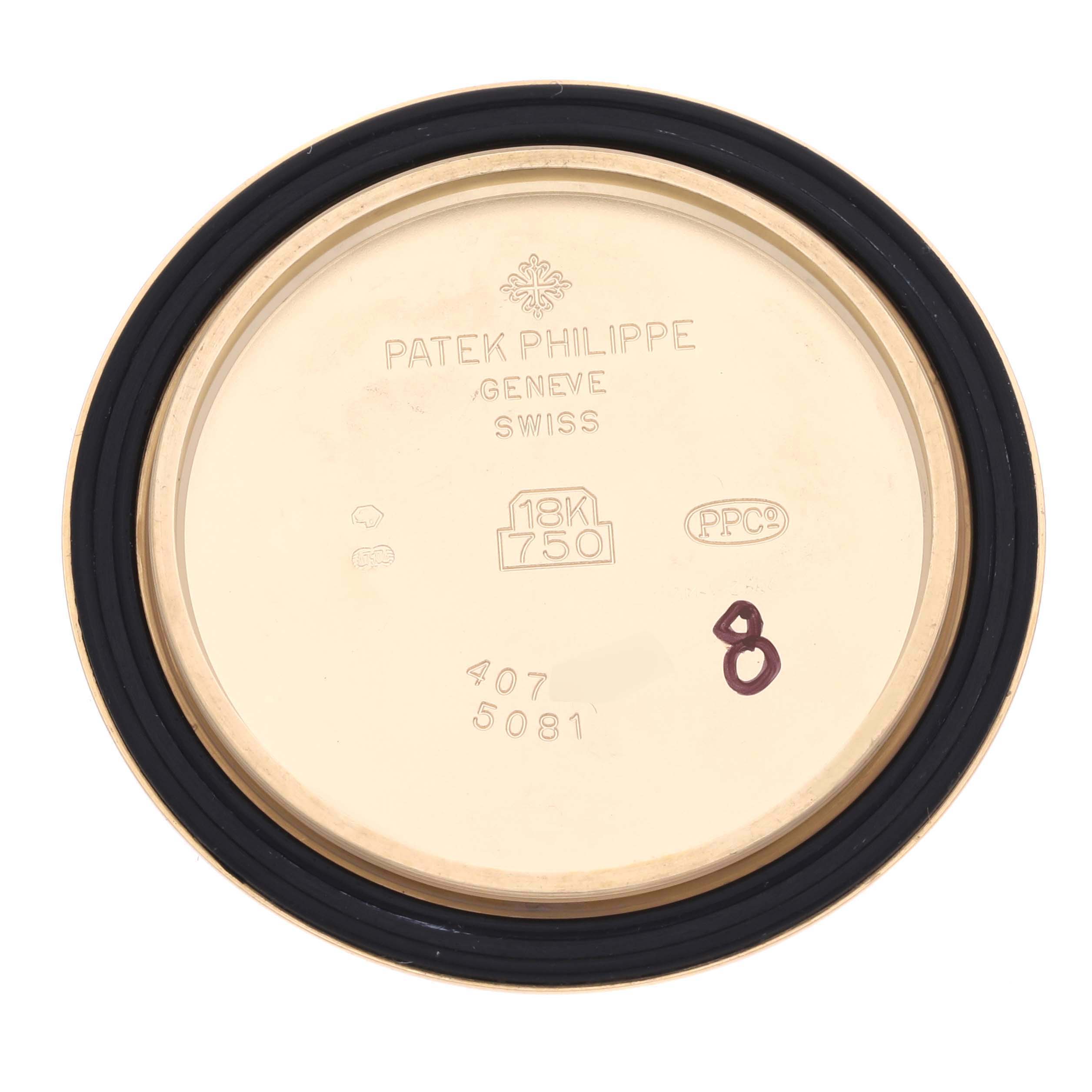 The image shows the back cover of a Patek Philippe Neptune 5081 Men's Yellow Gold Black Dial 5081 Men's Yellow Gold Black Dial watch, highlighting the 18K gold hallmark and engravings.