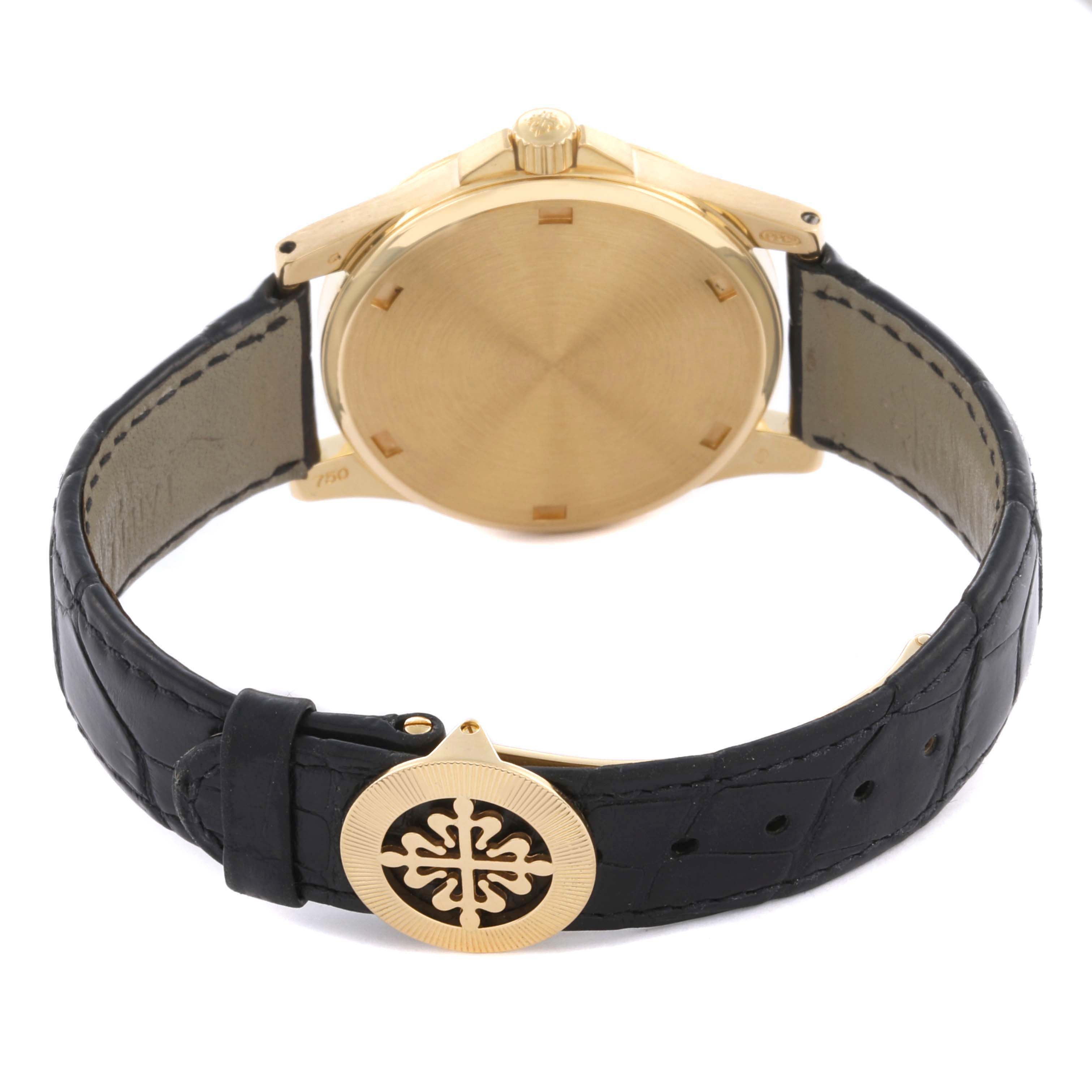 The image shows the back view of a Patek Philippe Neptune 5081 Men's Yellow Gold Black Dial 5081 Men's Yellow Gold Black Dial watch with a leather strap and gold case.