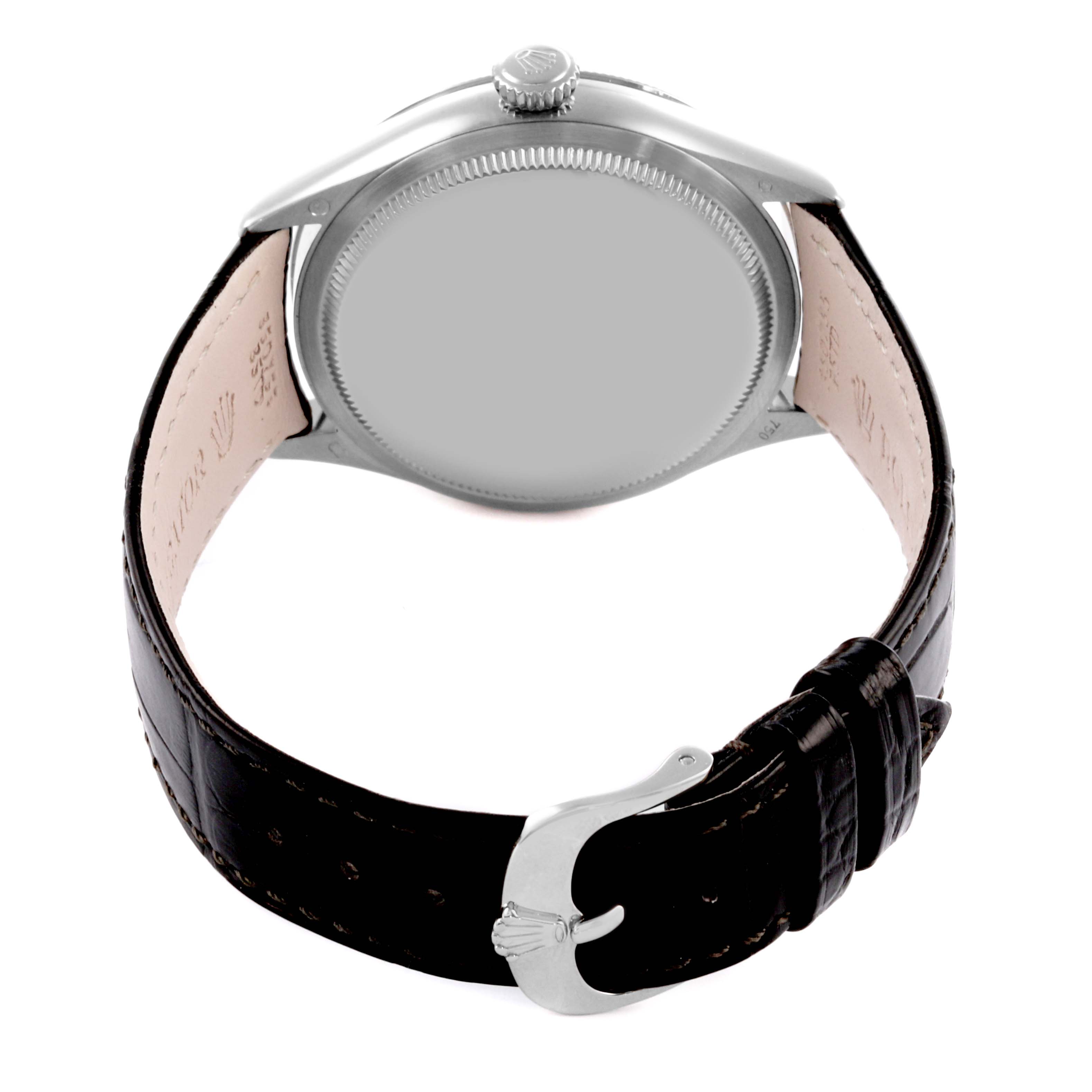 The Rolex Cellini 50609 Men's White Gold Black Dial 50609 Men's White Gold Black Dial watch is shown from the back, highlighting the case, crown, and black leather strap with a clasp.