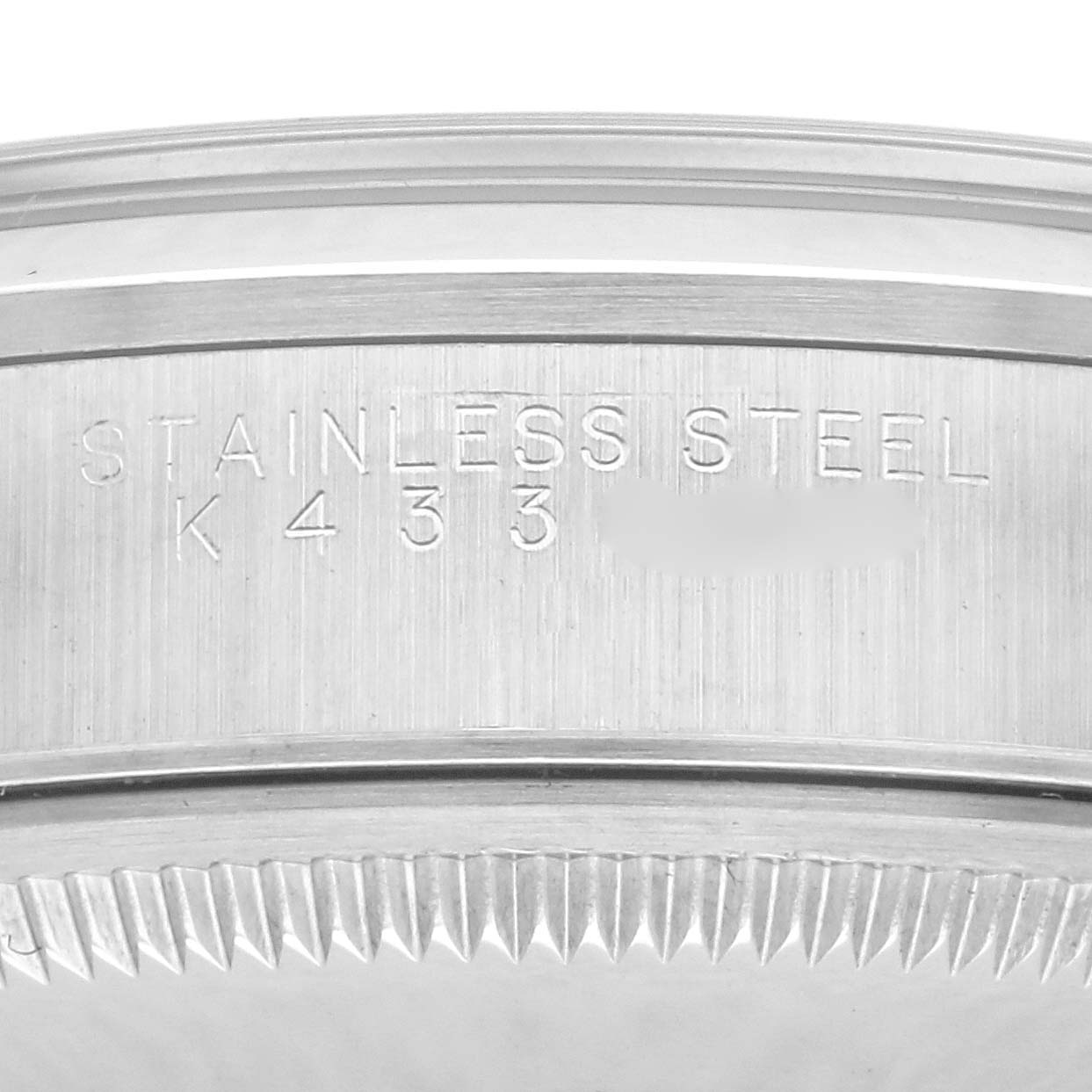 The image shows a close-up of the case back and serial engraving of a Rolex Date 15200 Men's Stainless Steel Blue Dial 15200 Men's Stainless Steel Blue Dial model.