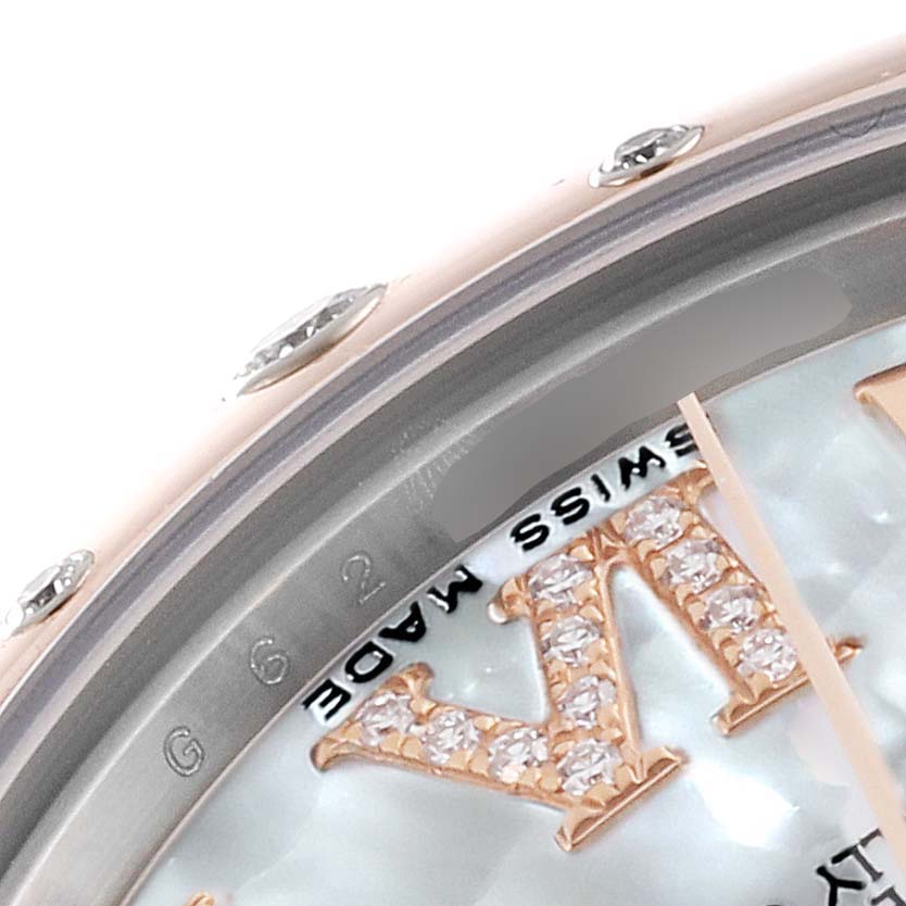 The image shows a close-up of the face and bezel of a Mid-Size Rolex watch, featuring diamond-studded Roman numerals.
