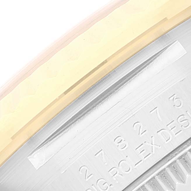 This close-up image captures the edge of the bezel and the engraved numbers on the case back of a Rolex Mid-Size 278273 Women
s Steel and Gold (two tone) Champagne Dial 278273 Women
s Steel and Gold (two tone) Champagne Dial watch.