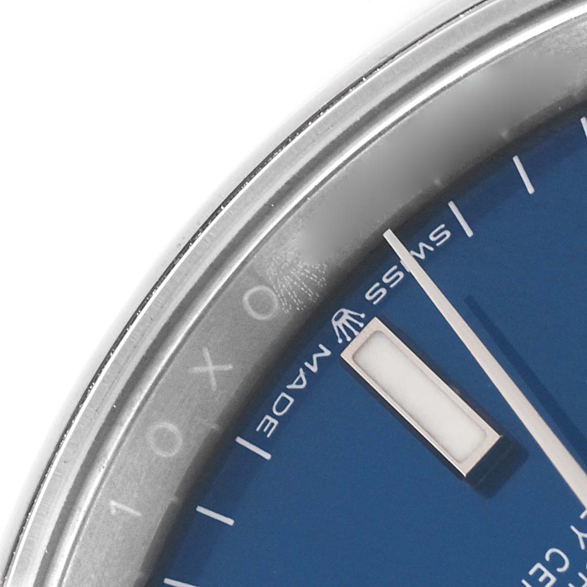 The image shows a close-up of the dial, bezel, and part of the minute hand of a Rolex Datejust 126200 Men's Stainless Steel Blue Dial 126200 Men's Stainless Steel Blue Dial watch.