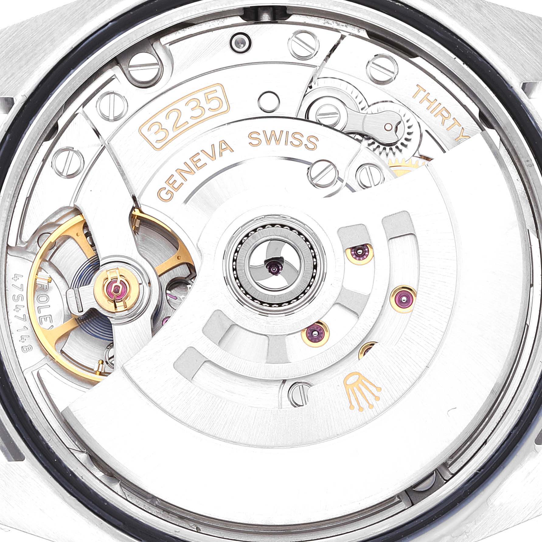 The image shows a close-up view of the movement of a Rolex Datejust 126200 Men's Stainless Steel Blue Dial 126200 Men's Stainless Steel Blue Dial watch, revealing the intricate inner mechanisms and parts like the rotor and balance wheel.