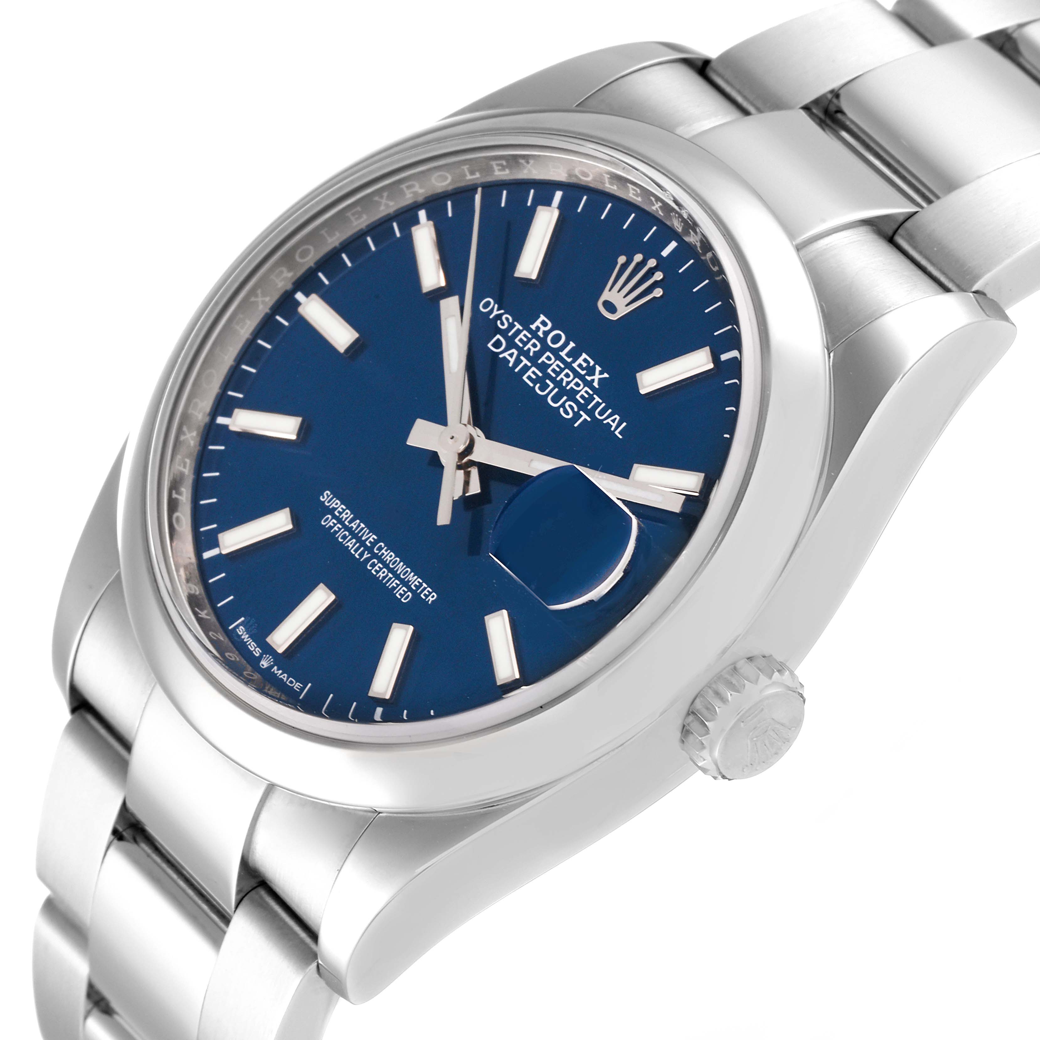 This is a close-up angled shot of a Rolex Datejust 126200 Men's Stainless Steel Blue Dial 126200 Men's Stainless Steel Blue Dial wristwatch, featuring its blue dial, luminous markers, and signature stainless steel bracelet.