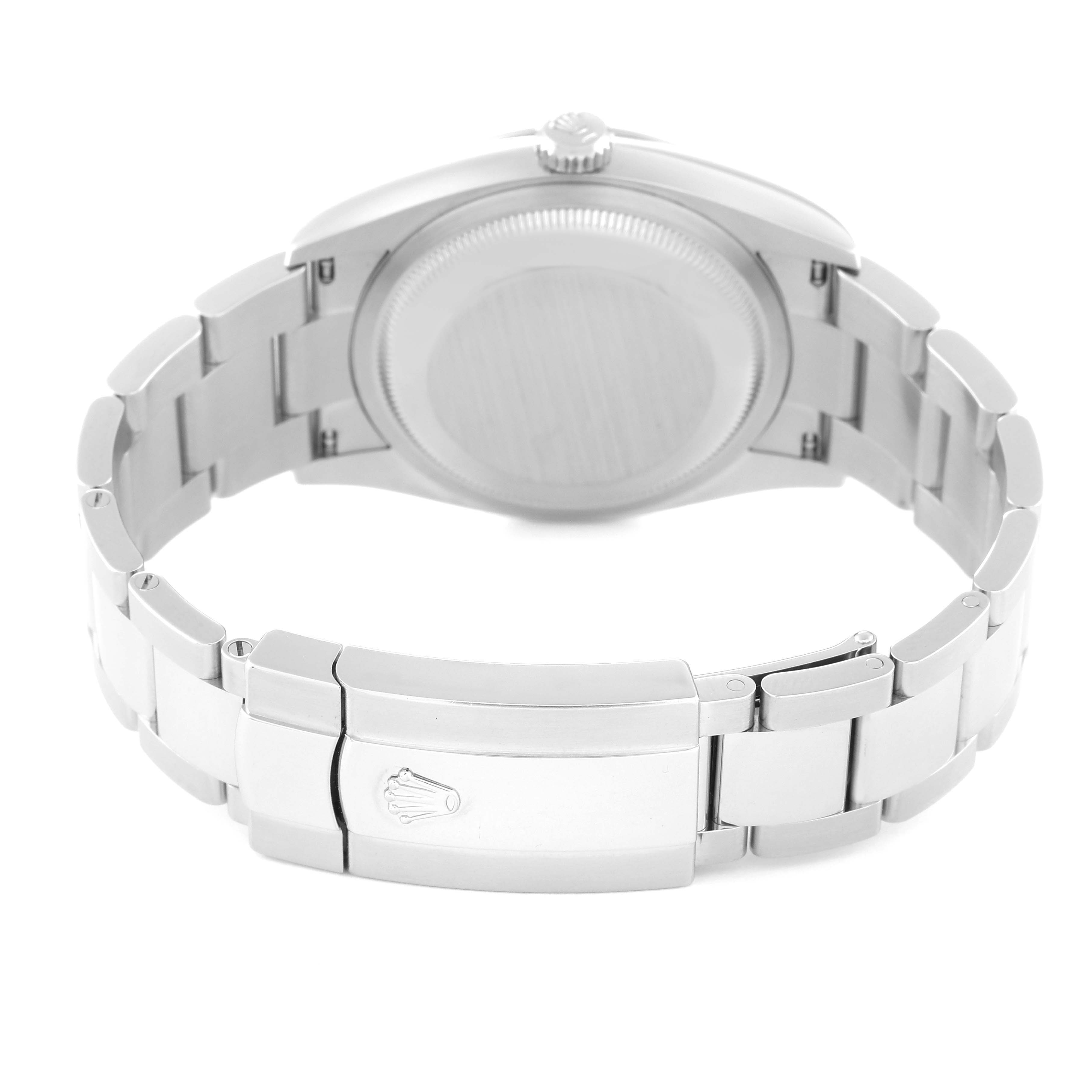 The image shows the underside of a Rolex Datejust 126200 Men's Stainless Steel Blue Dial 126200 Men's Stainless Steel Blue Dial watch, focusing on the case back and a closed clasp on the bracelet.