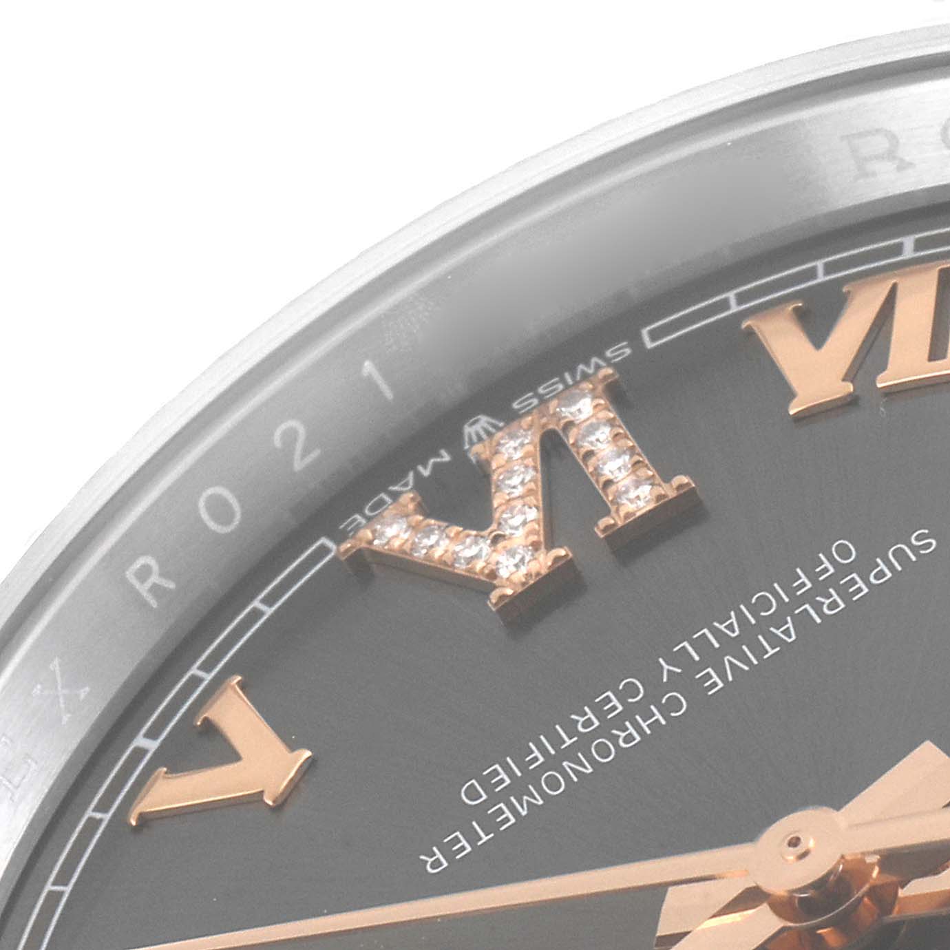 This image shows a close-up of the dial of a Rolex Datejust 126231 Men's Steel and Gold (two tone) Grey Dial 126231 Men's Steel and Gold (two tone) Grey Dial watch with focus on parts of the Roman numeral markers and text.