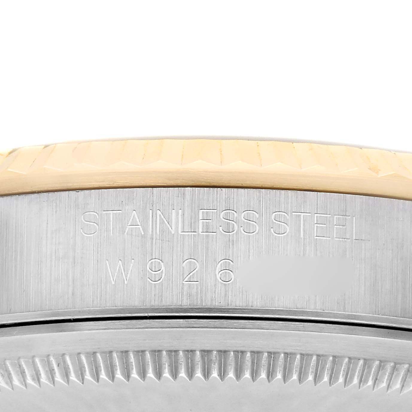 The image shows a close-up of the Rolex Datejust 16233 Men
s Steel and Gold (two tone) Champagne Dial 16233 Men
s Steel and Gold (two tone) Champagne Dial watch
s side with the stainless steel engraving and part of the bezel visible.